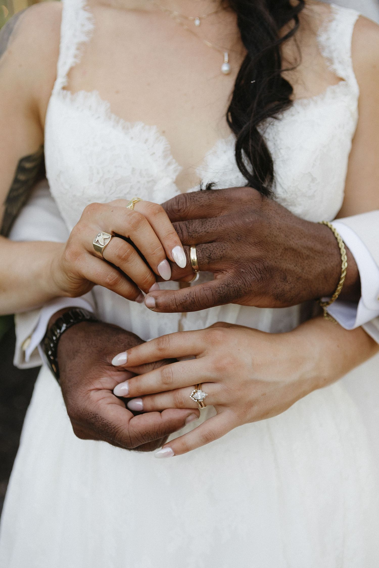 Close-up of hands exchanging wedding rings during ceremony.