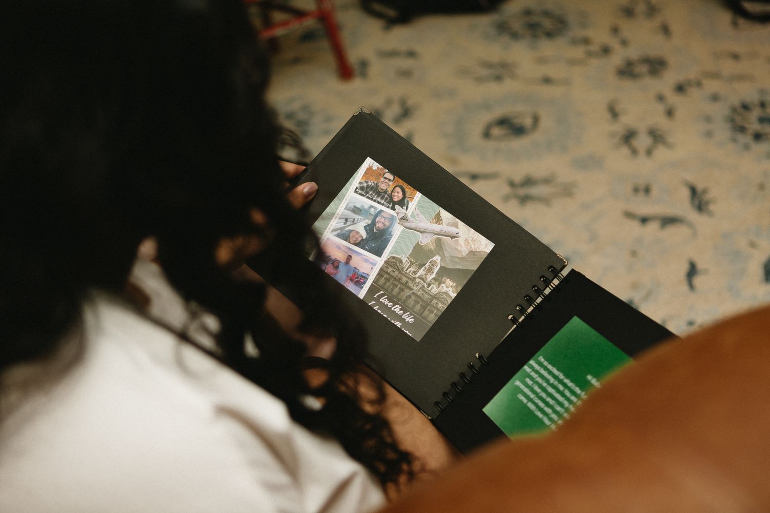 Someone reading a publication or magazine with printed content and a green section visible.