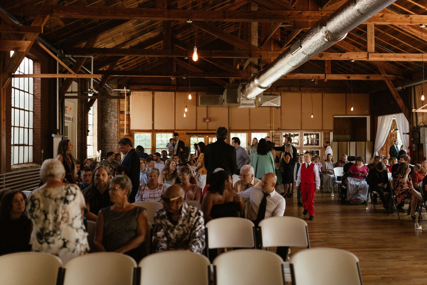 wedding guest arriving to wooden wedding venue