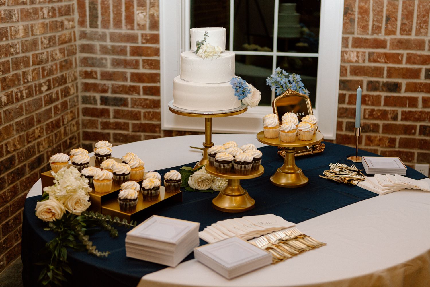 Beautifully decorated wedding cake and dessert table setup