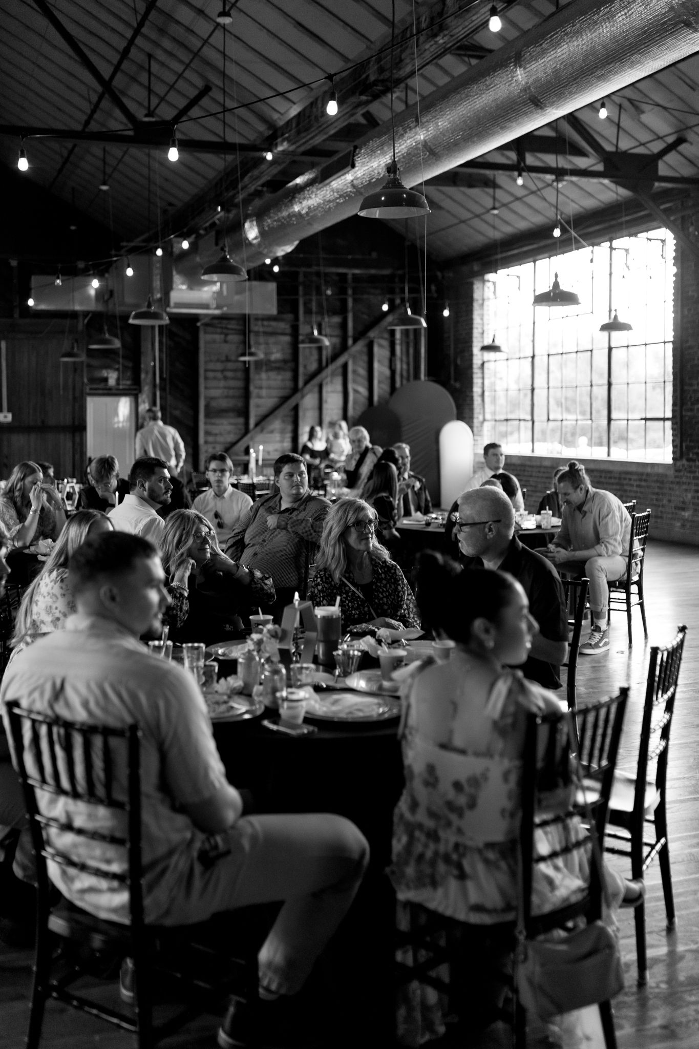 guest watching bride and groom share a first dance at wedding venue