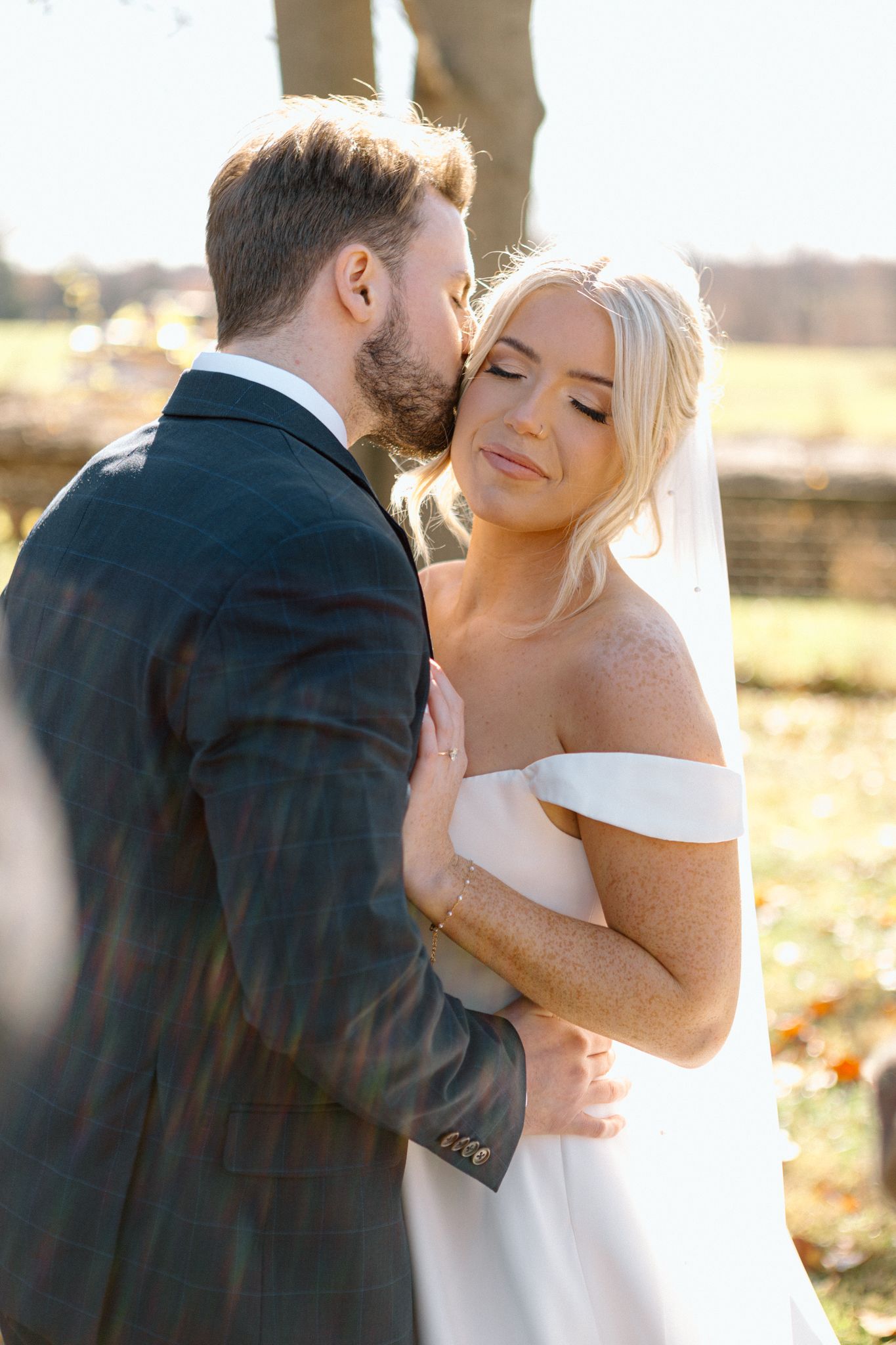 Bride and groom posing with a lush bouquet at Silo Farms. Photo by Joia Lyn, KY wedding photographer