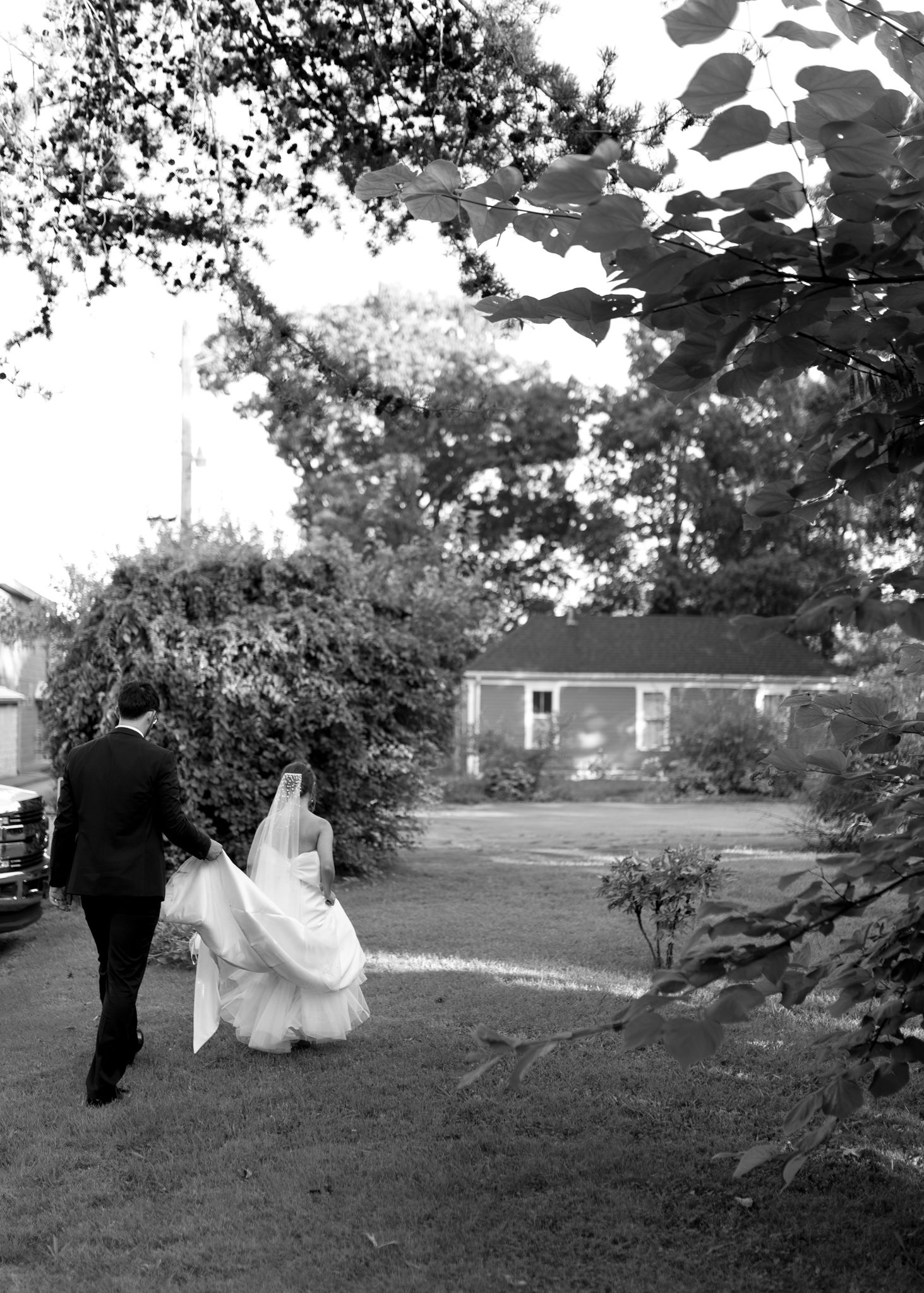 Romantic outdoor wedding photo of the bride and groom in a grassy field