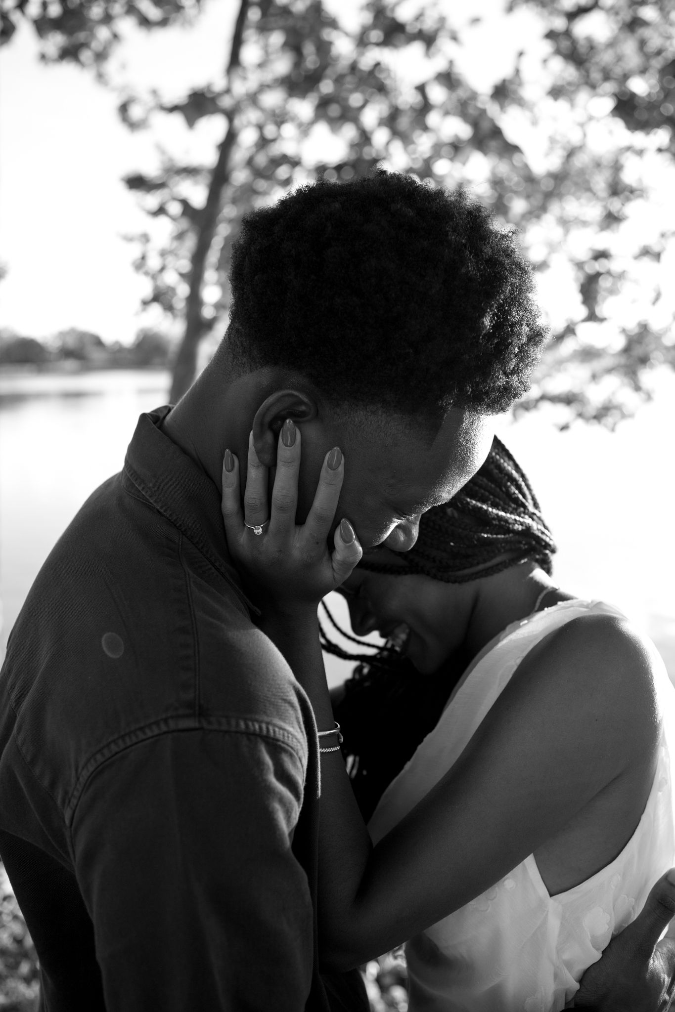 Romantic proposal at a lakeside location in Lexington, Kentucky, with a young Black couple.