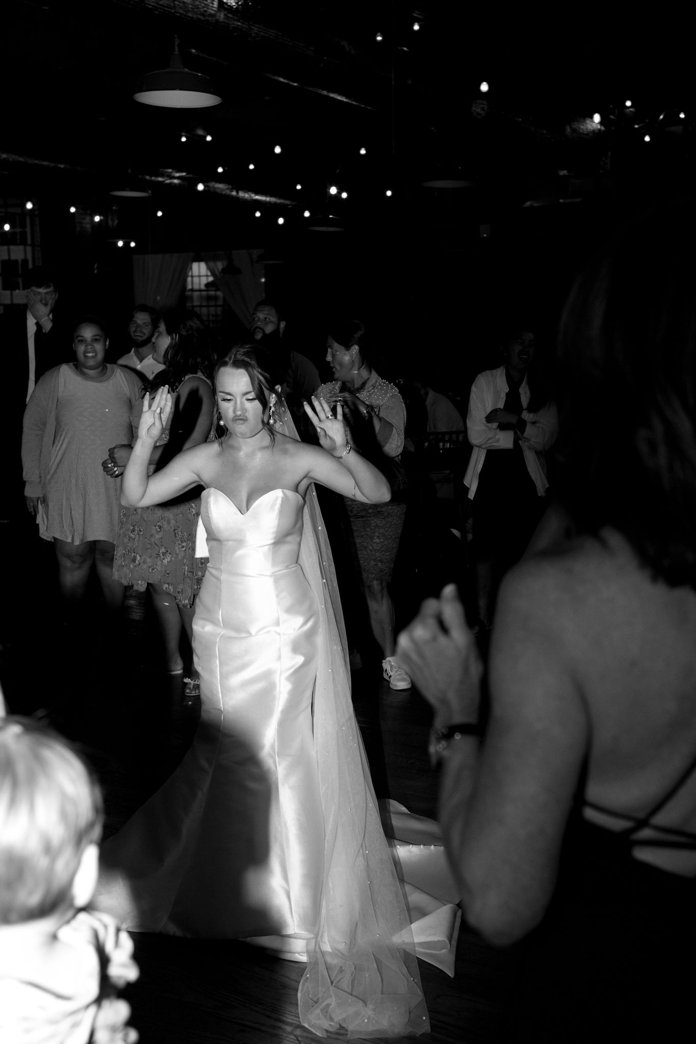 Fun-filled wedding reception with guests dancing to live music.