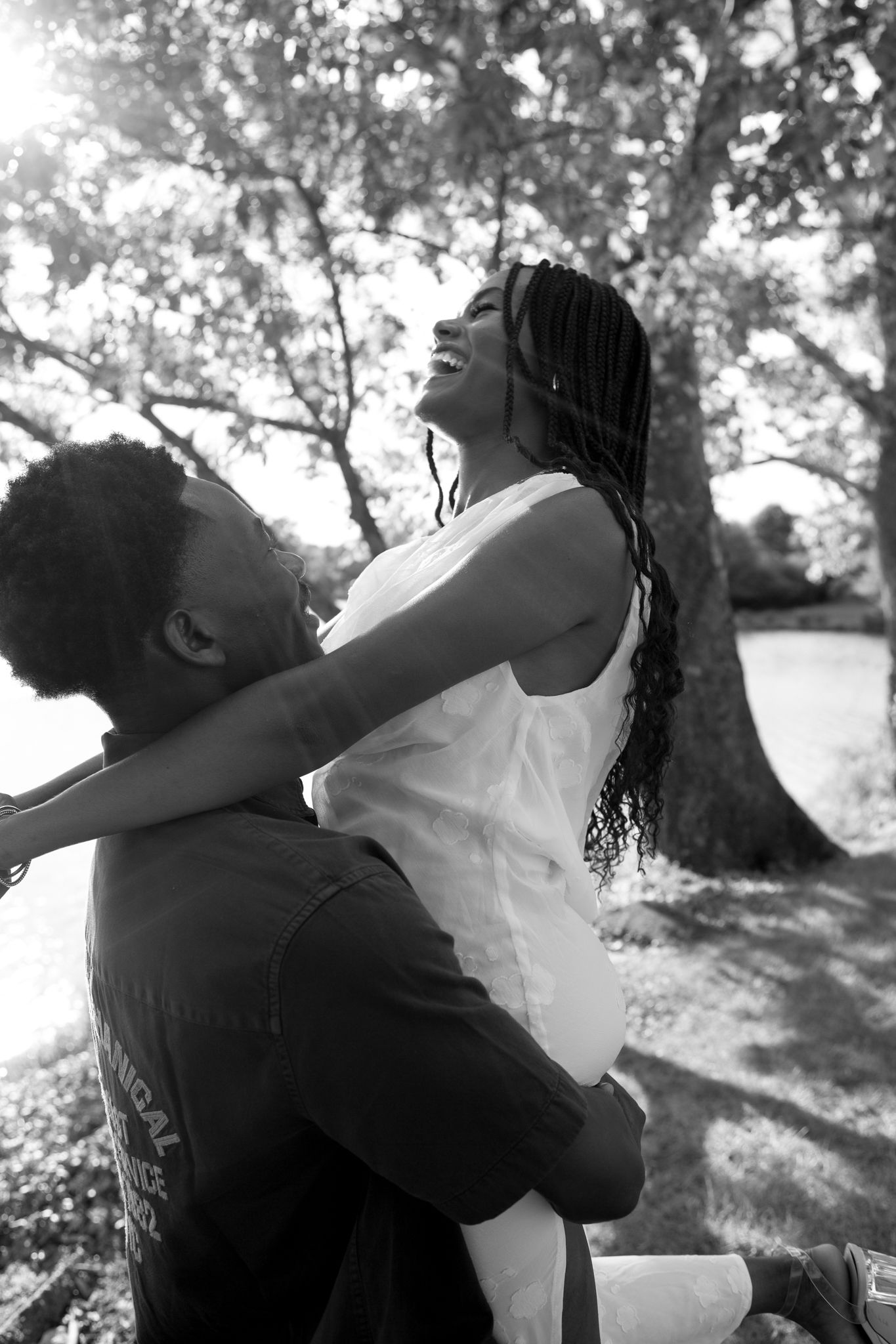 Romantic proposal at a lakeside location in Lexington, Kentucky, with a young Black couple.