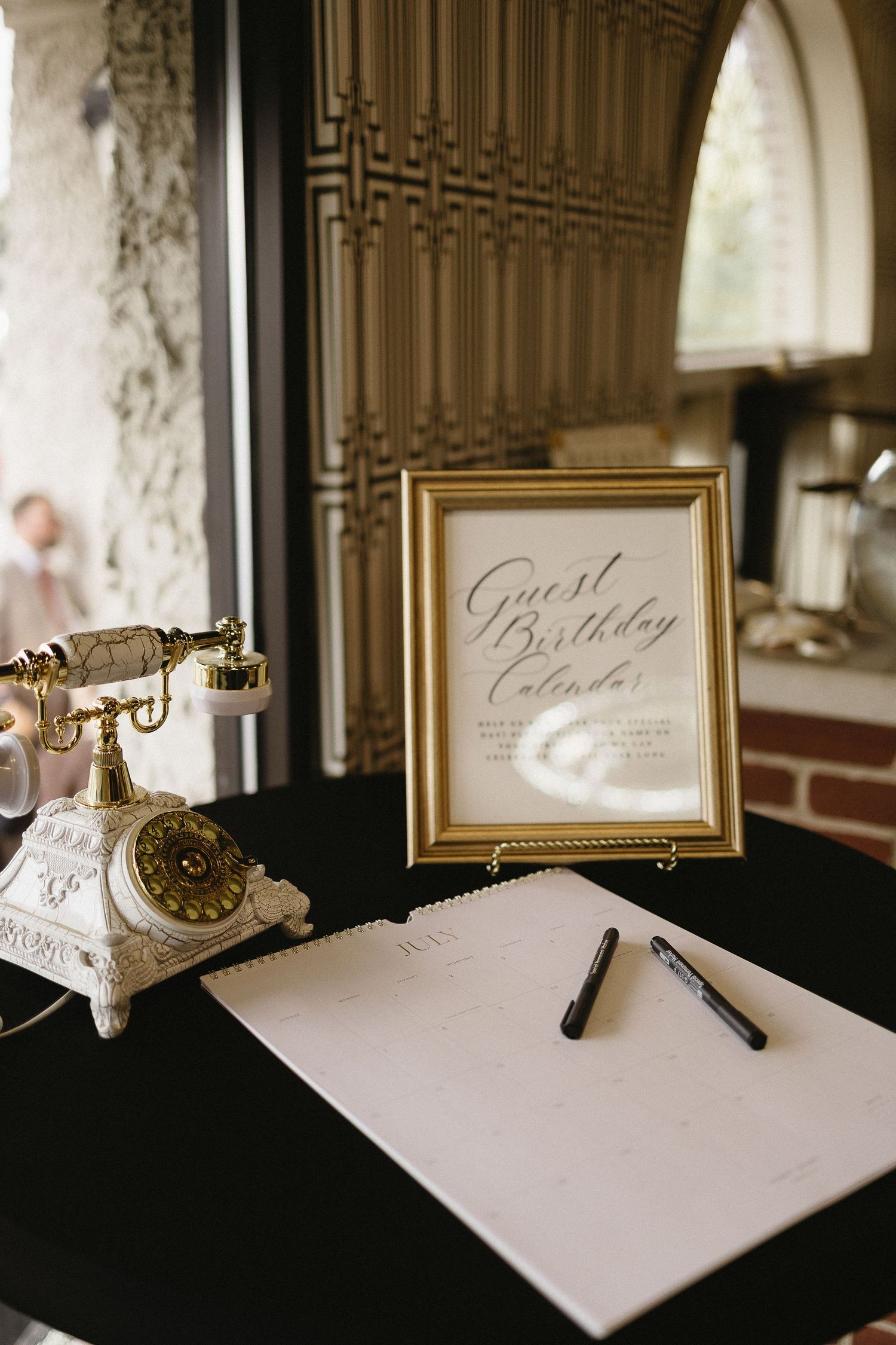 Elegant wedding guest book table with calligraphy cards and vintage decor.
