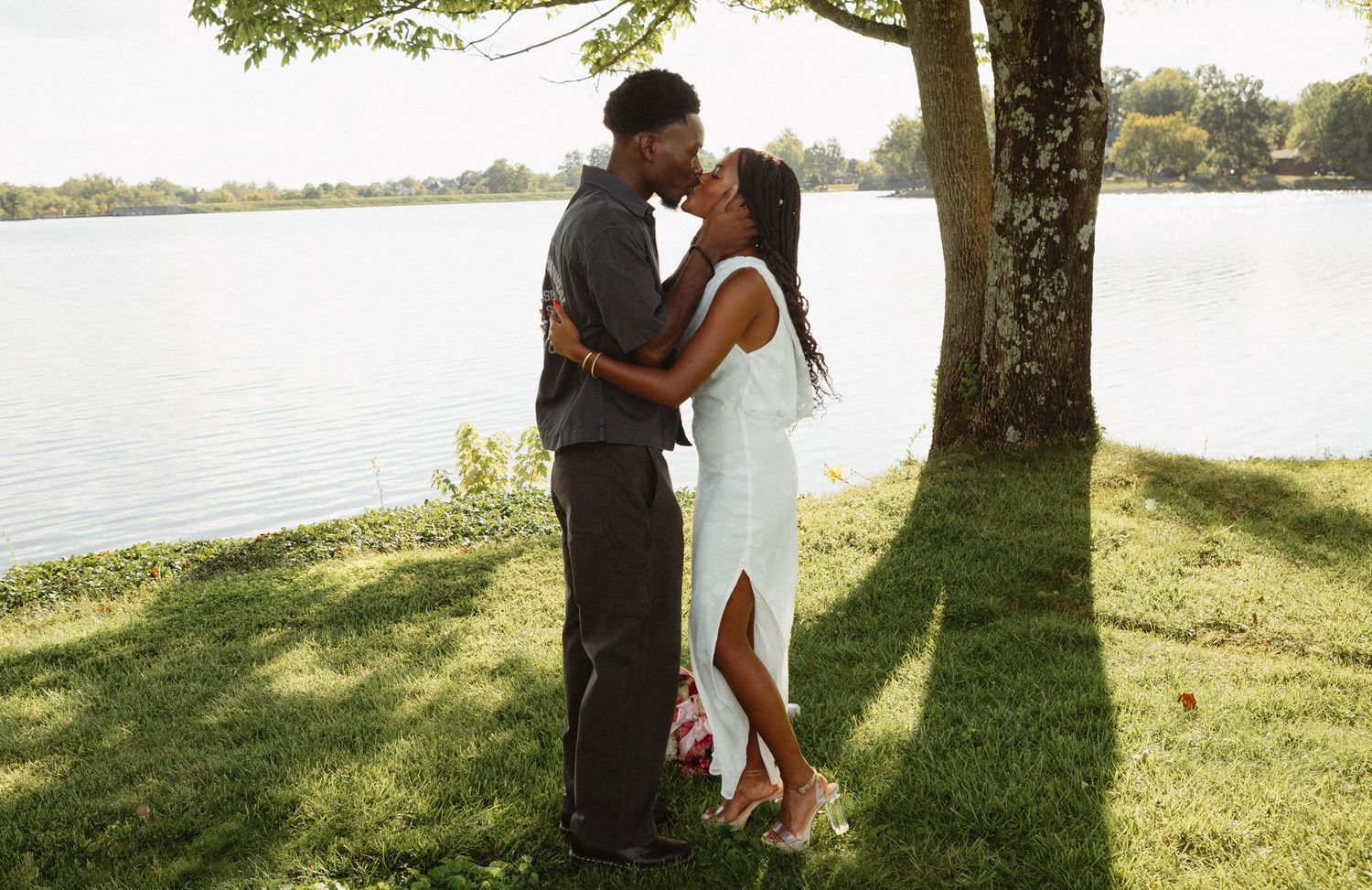 Joyful moment as Belle says yes to Chadrack's proposal by a peaceful lake in Kentucky.