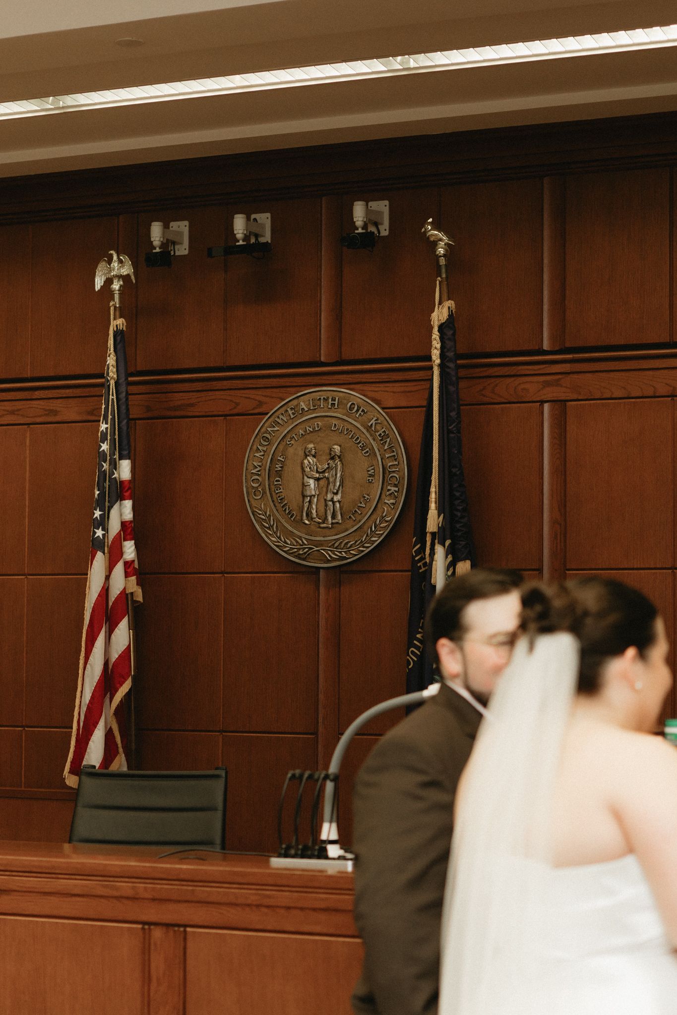 A sequence of wedding ceremony photos showing a couple at the altar with American flags and official seals in the background.