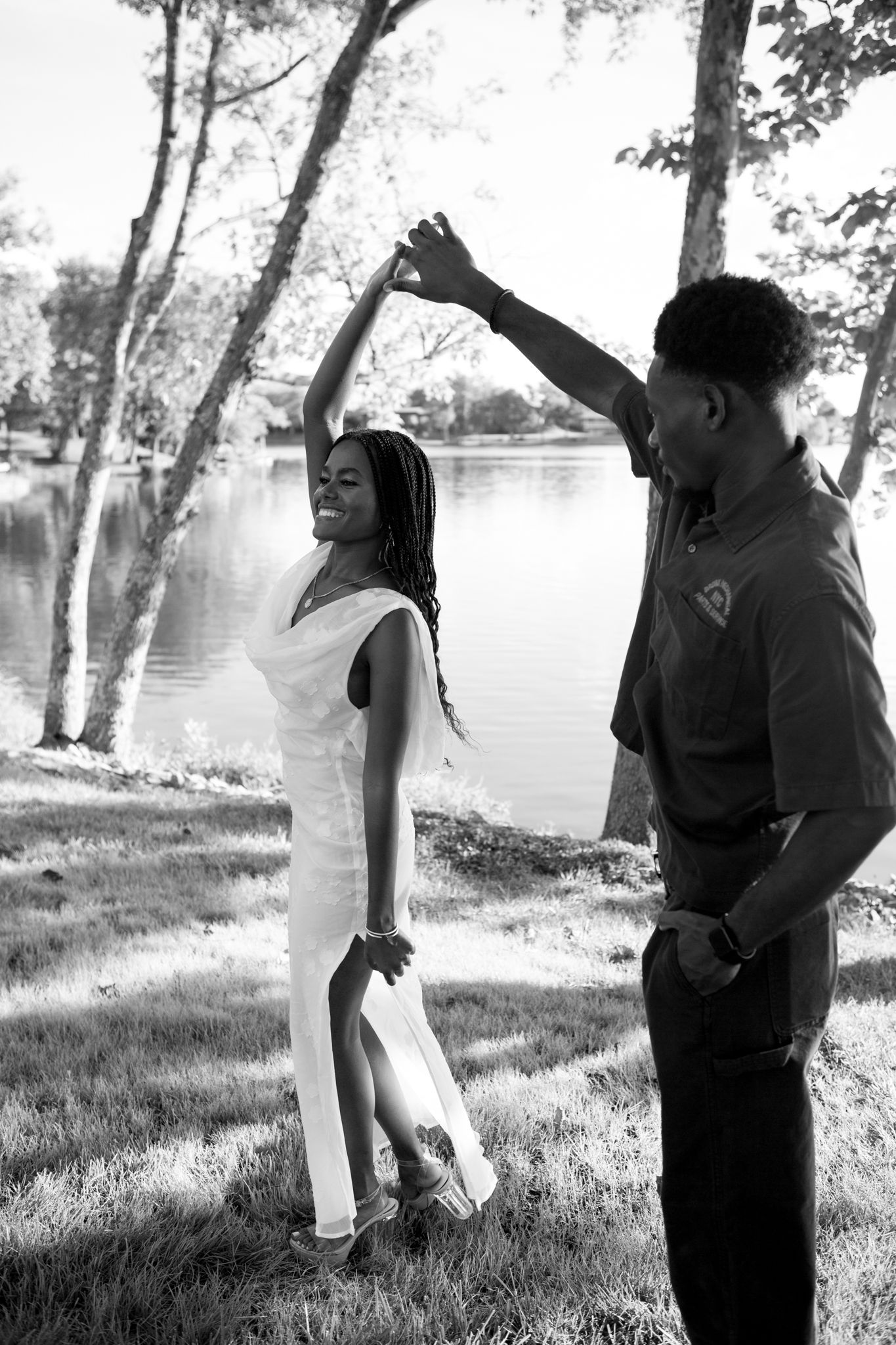 Newly engaged couple, Belle and Chadrack, holding hands and smiling during their proposal photoshoot in Kentucky.