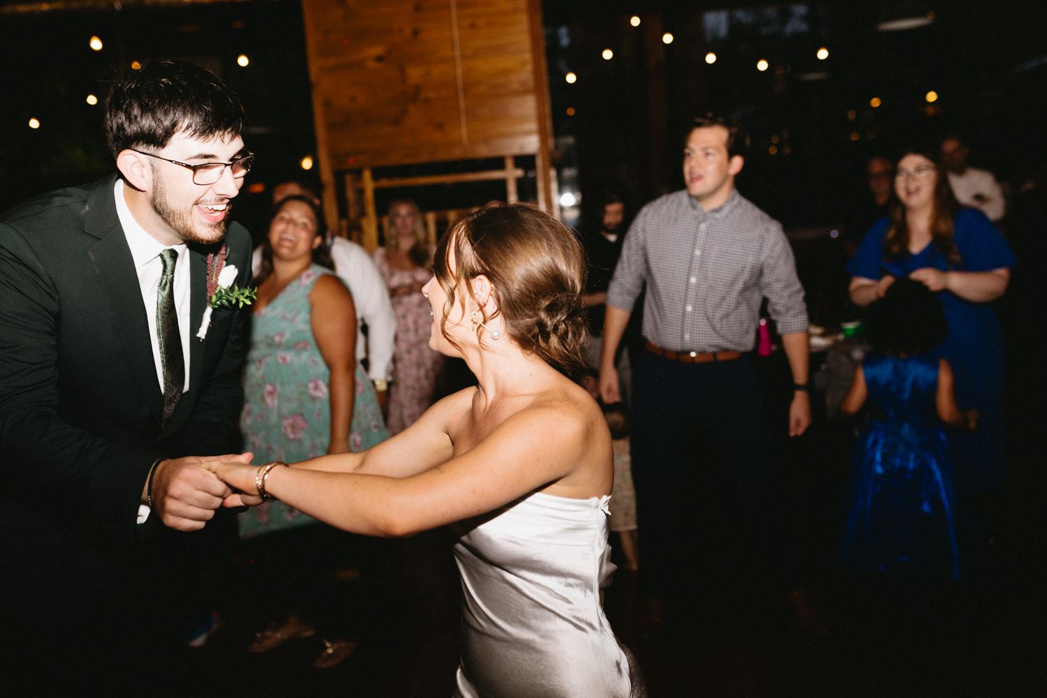 Happy couple surrounded by friends and family on the dance floor