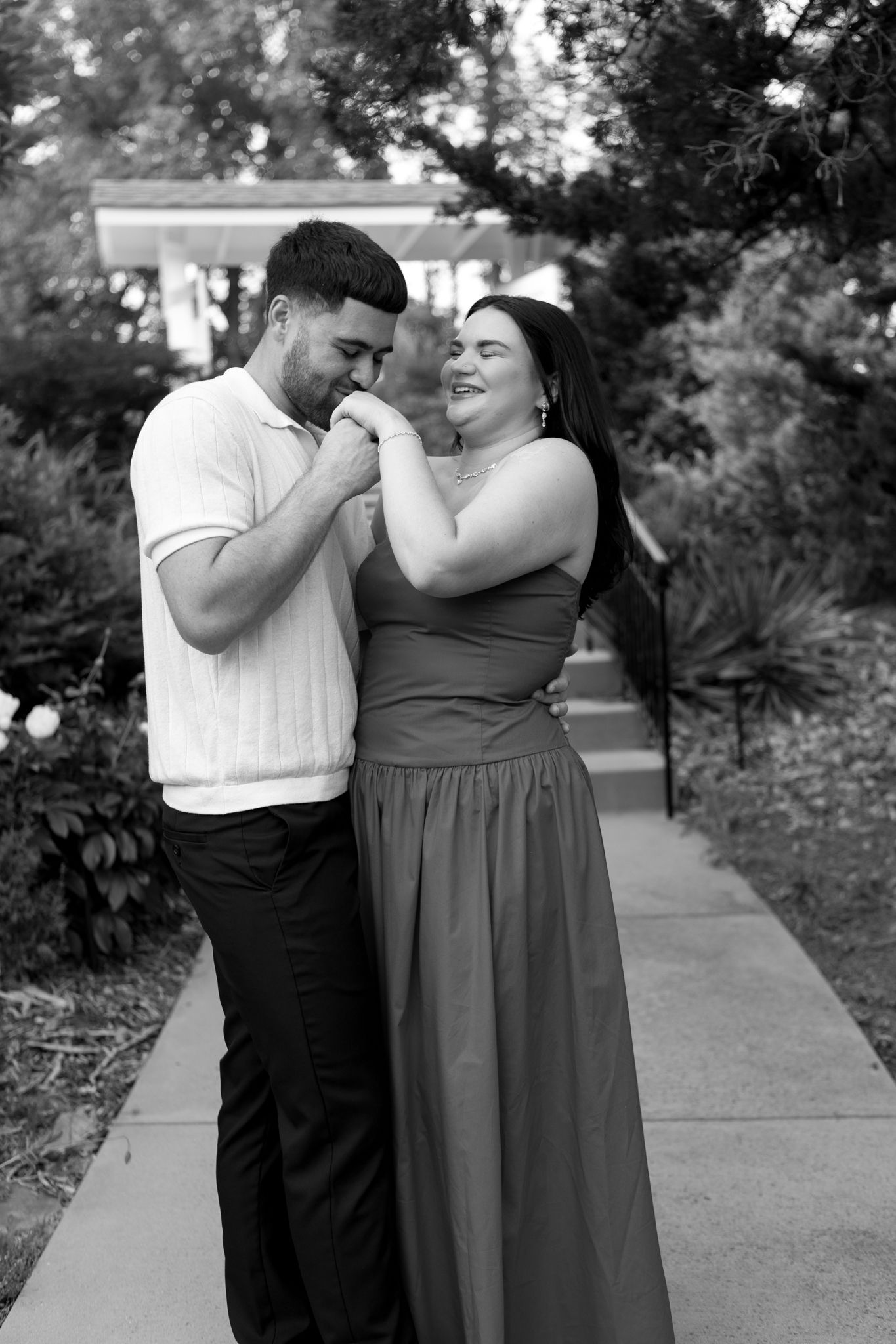 Black and white photo sequence showing tender moments between couple on garden pathway.