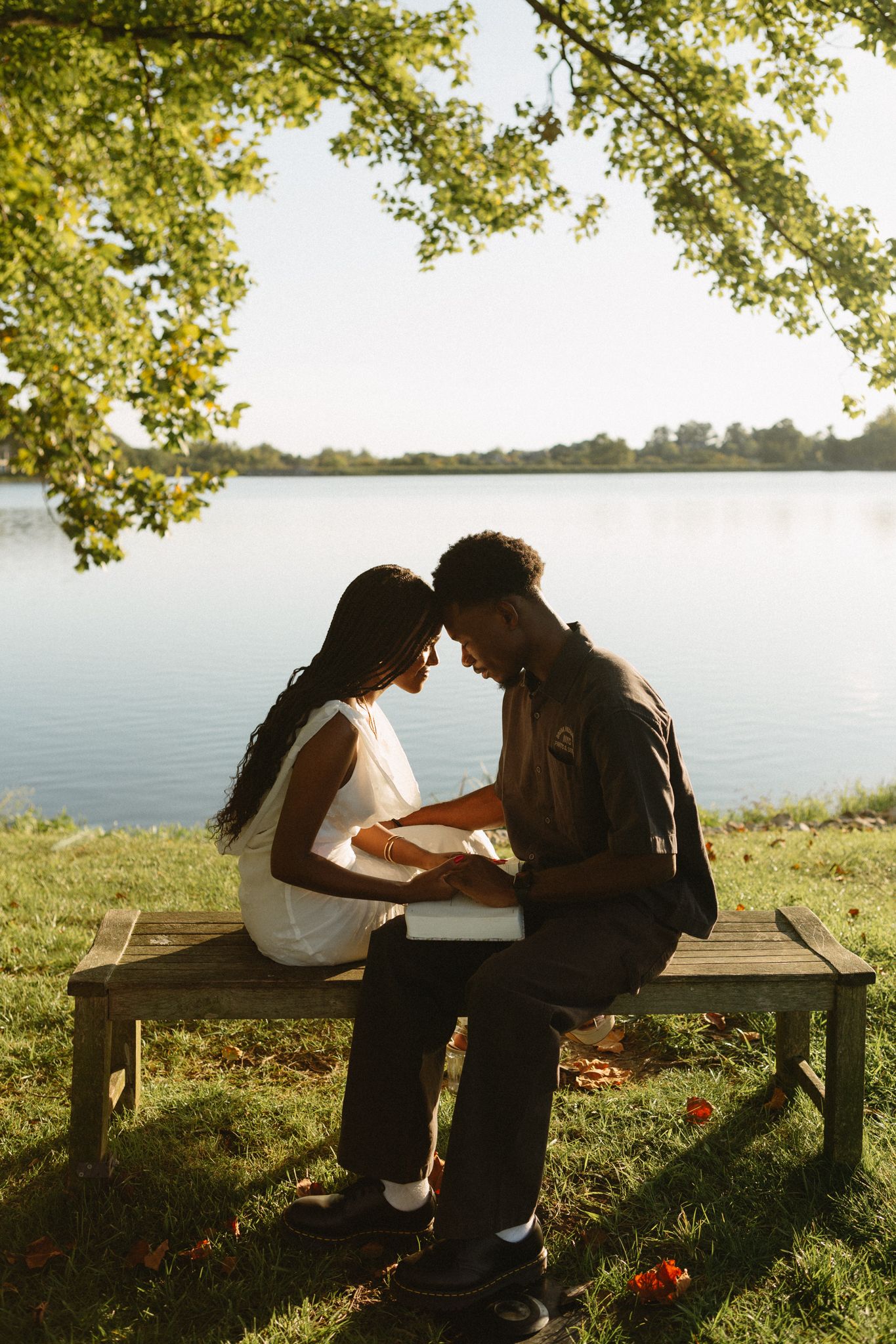 Romantic proposal at a lakeside location in Lexington, Kentucky, with a young Black couple.