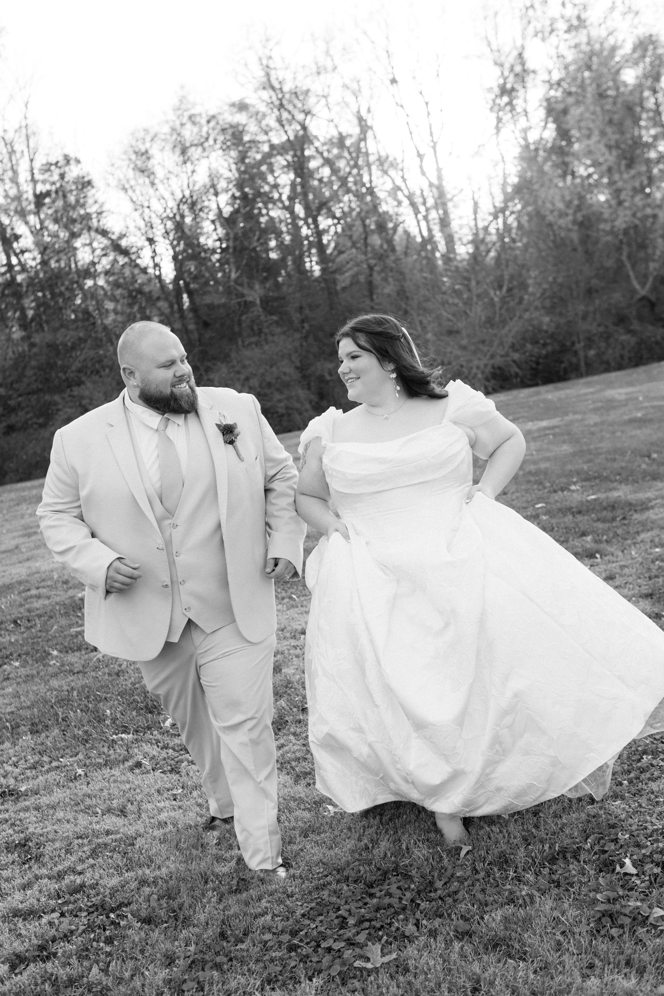 A series of black and white photos showing a couple in wedding attire playfully twirling and dancing in a grassy field.