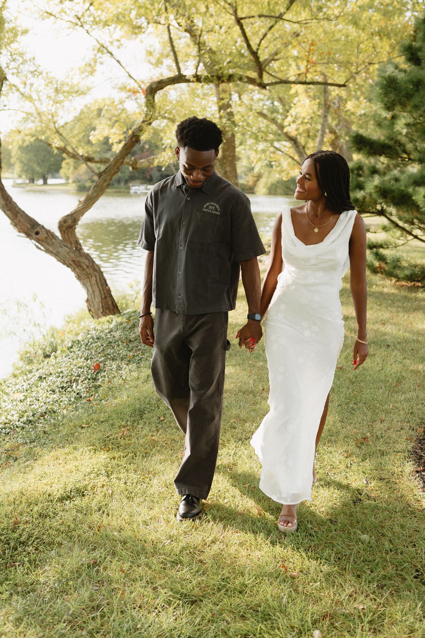 Engaged Black couple sharing a quiet, loving moment under tall trees in Lexington, KY.