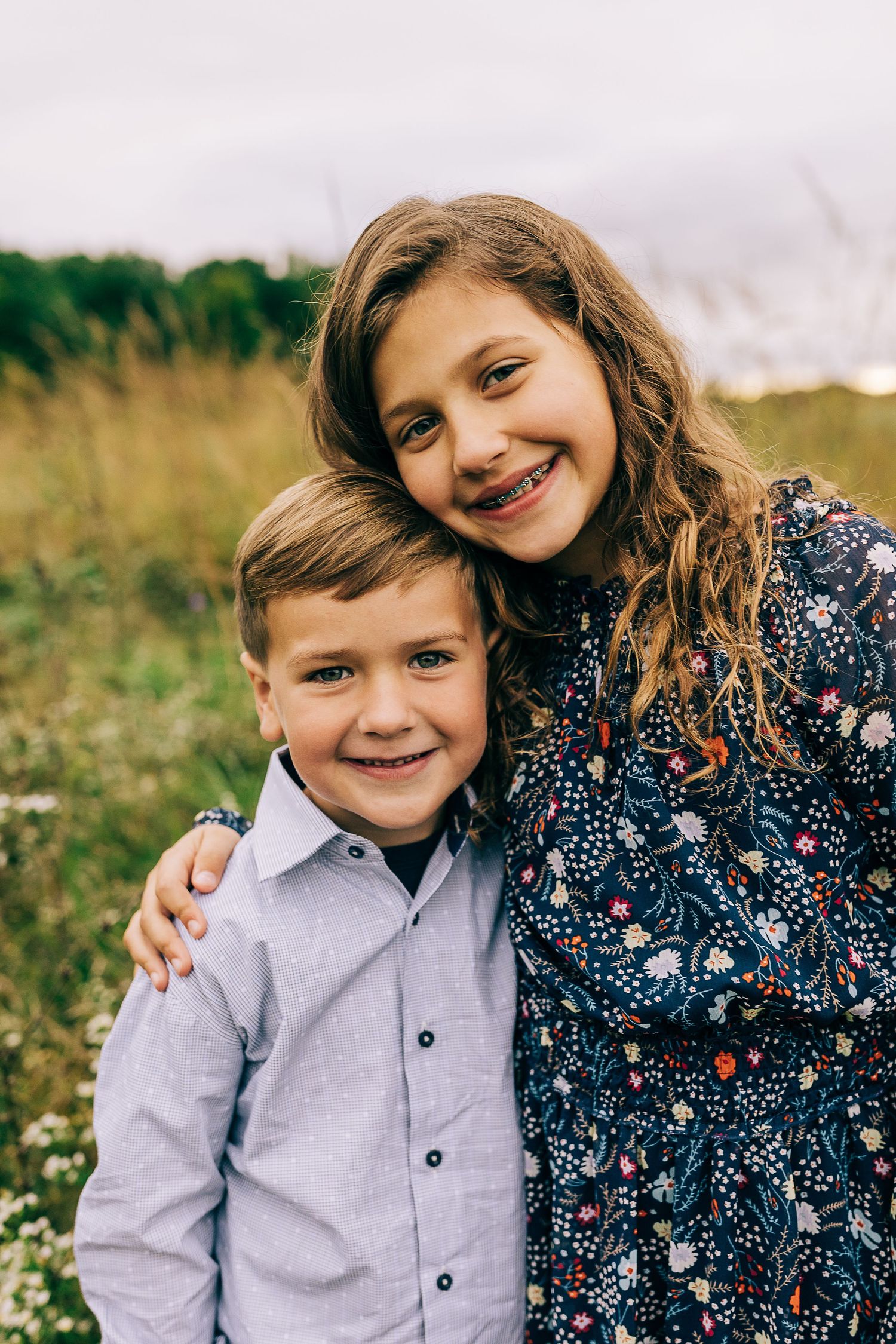 Family in a grassy field at sunset.