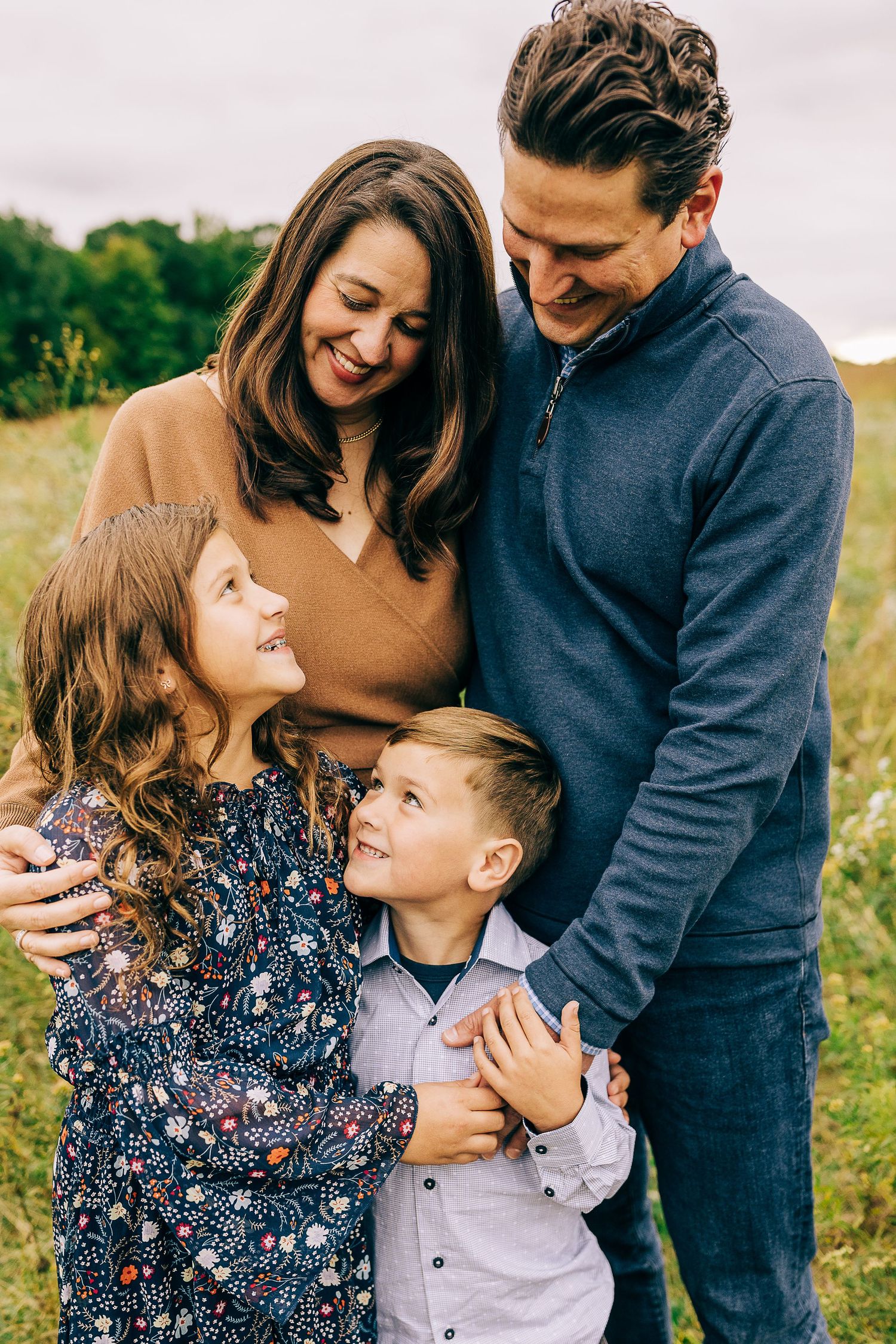 Family in a grassy field at sunset.