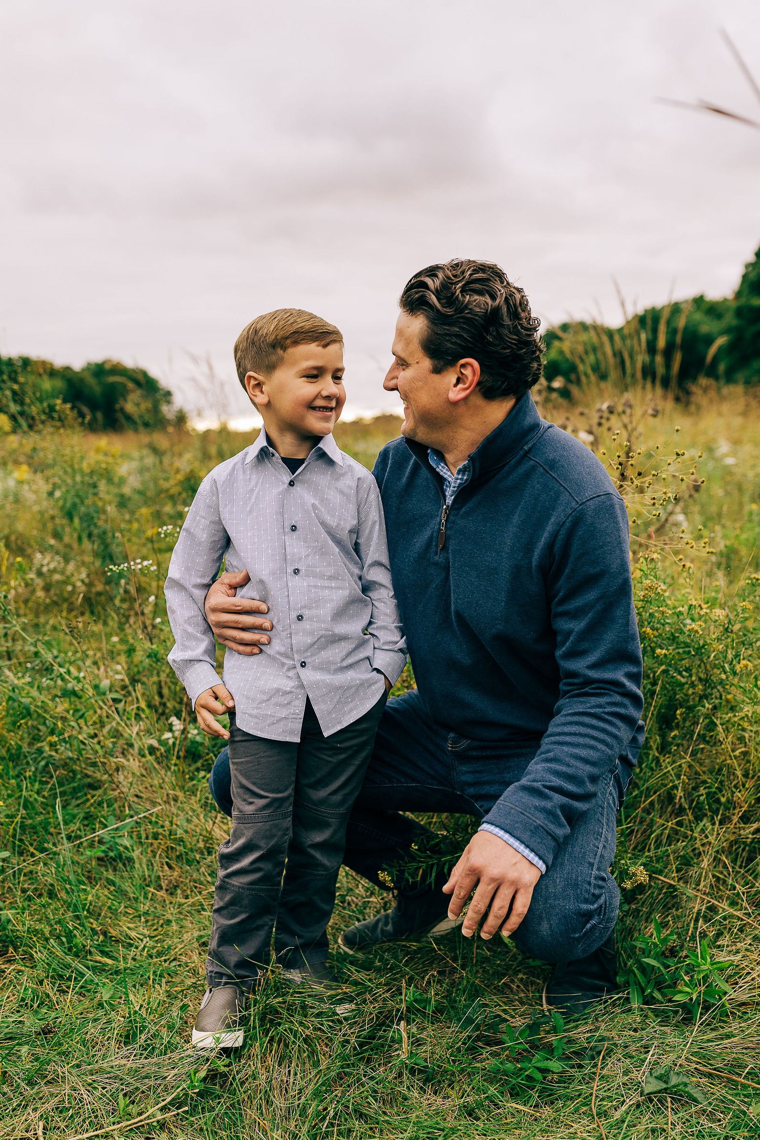Family in a grassy field at sunset.
