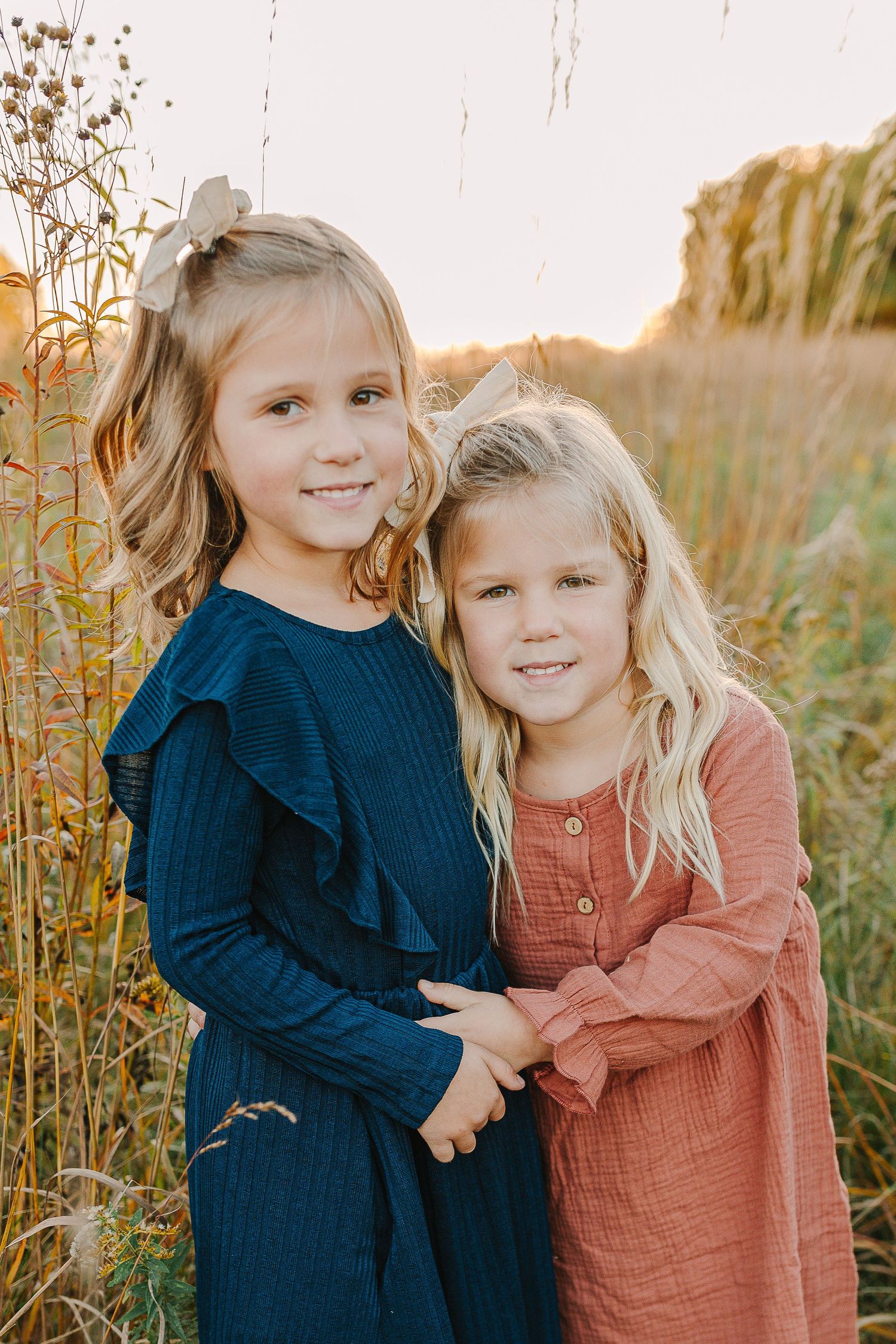 Family in a grassy field at sunset.