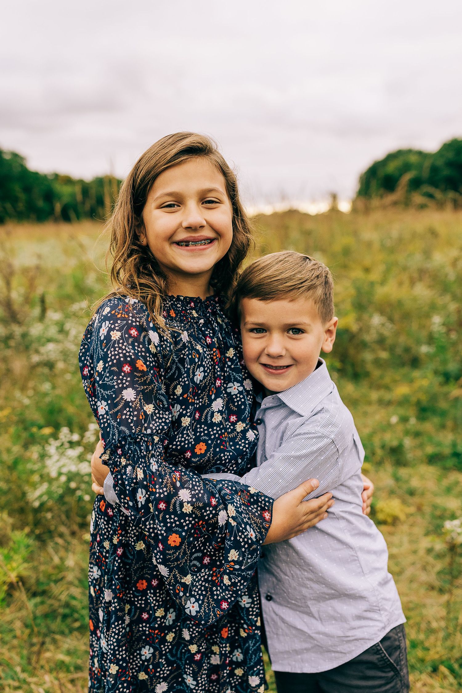 Family in a grassy field at sunset.