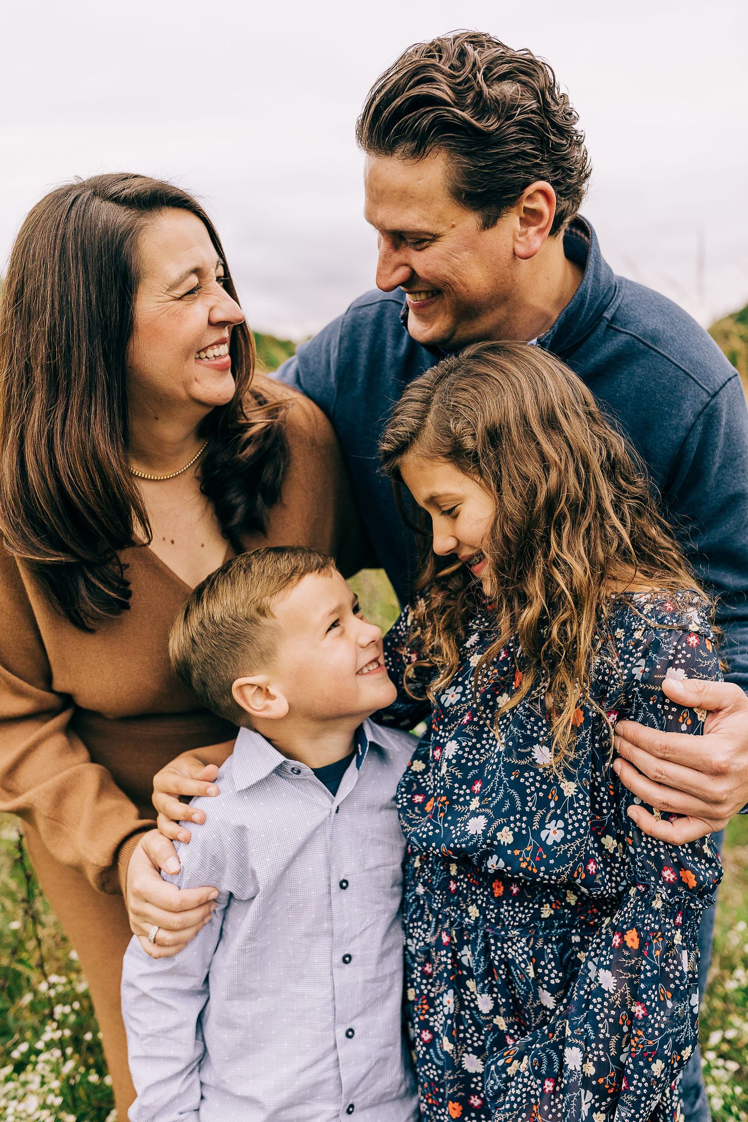 Family in a grassy field at sunset.