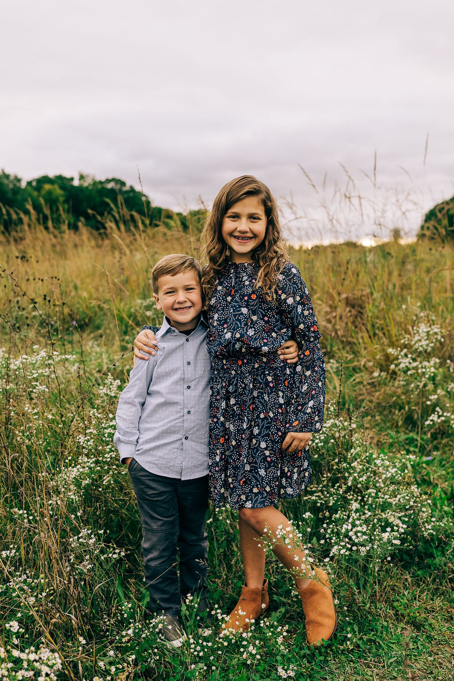 Family in a grassy field at sunset.
