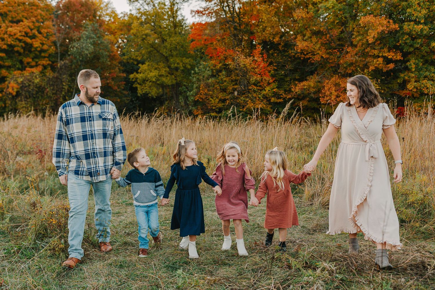 Family in a grassy field at sunset.