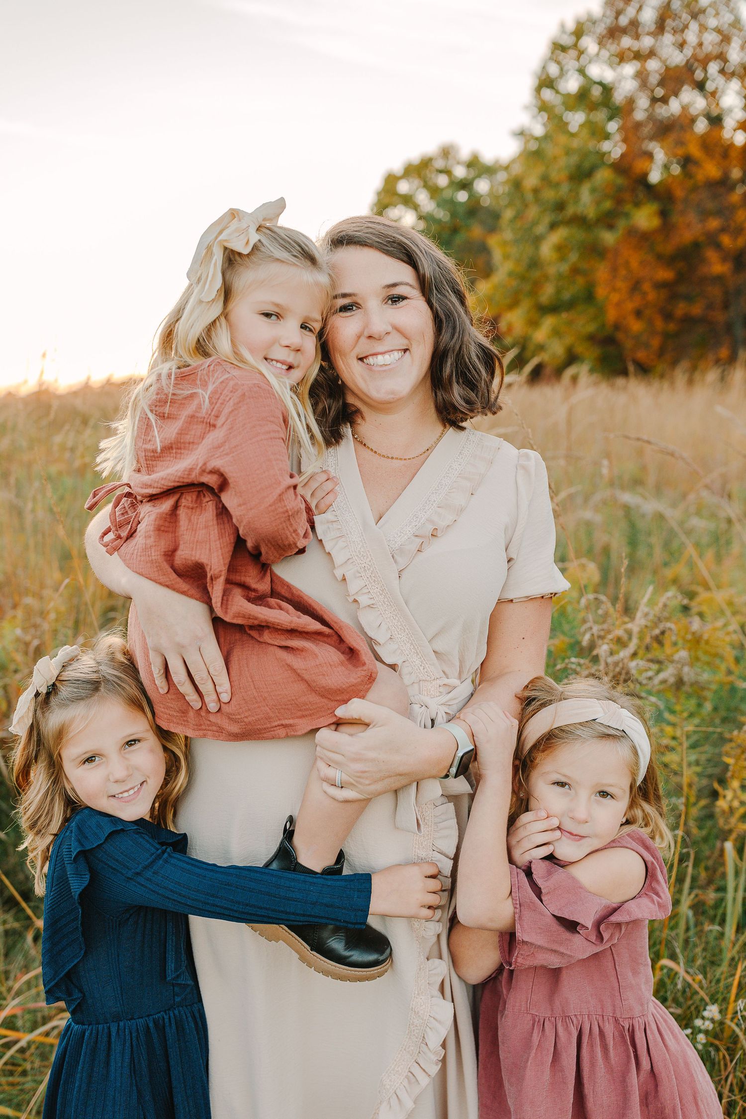 Family in a grassy field at sunset.