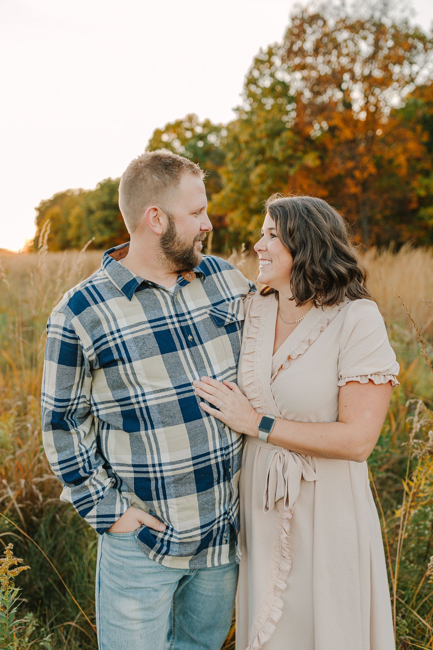 Family in a grassy field at sunset.