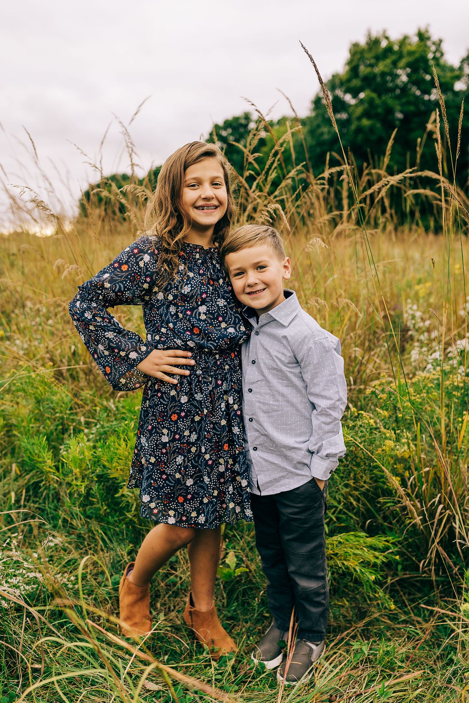 Family in a grassy field at sunset.