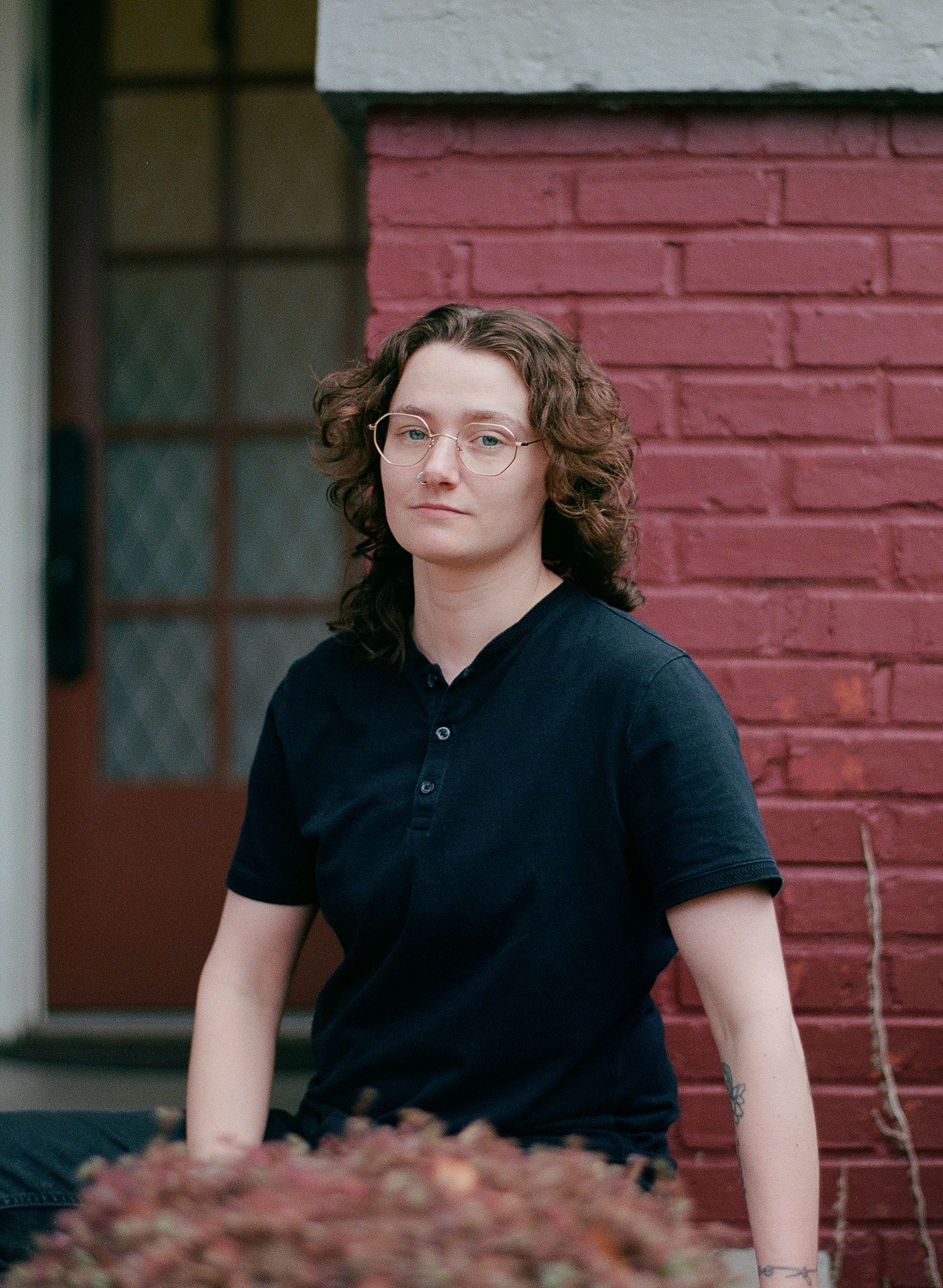 Fine art portrait of a white woman with glasses and curly brown hair captured in high-resolution medium format film photography style.