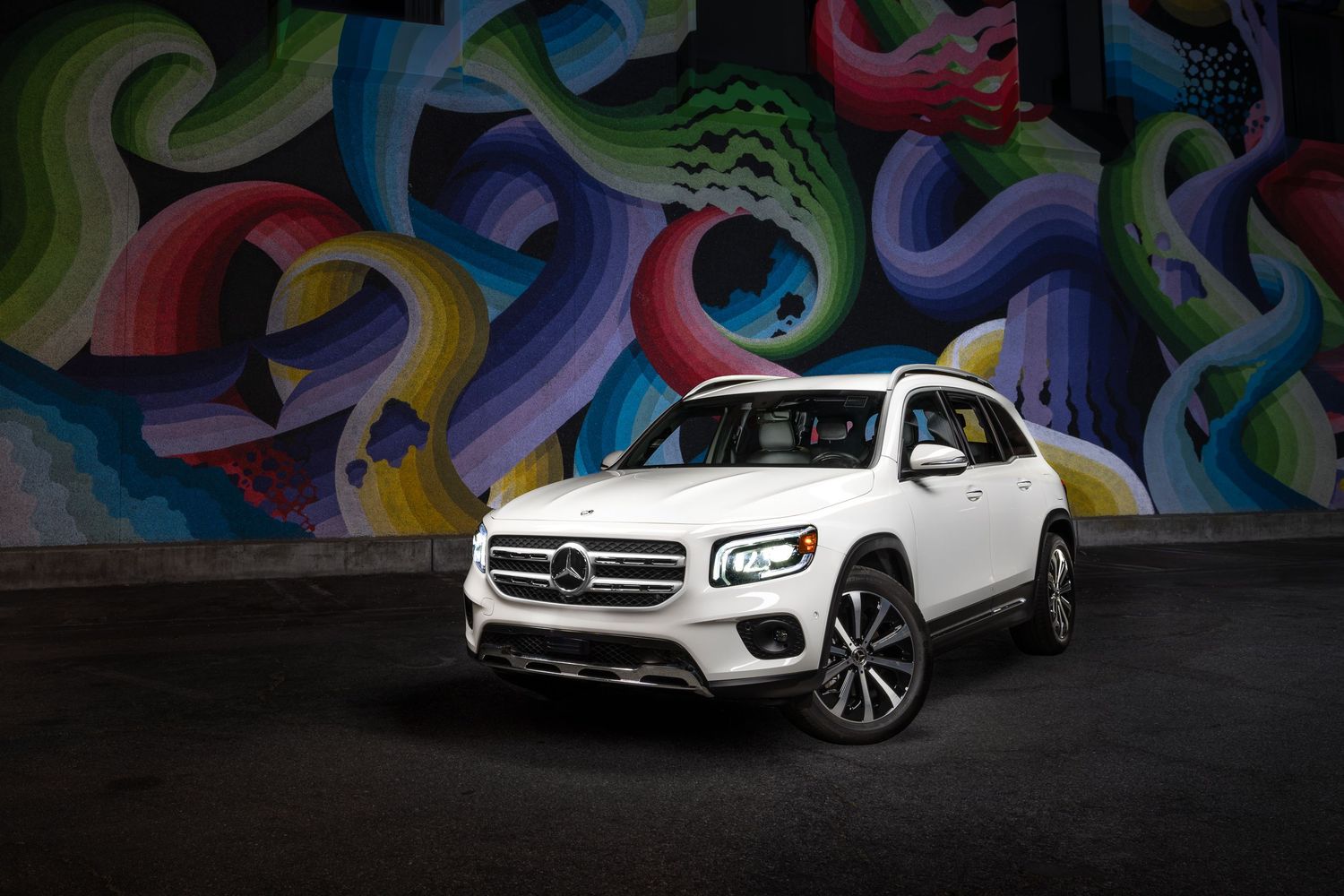 A John Gayler light painted fine art wall portrait of a white Mercedes Benz GLB SUV  with Eye of the Storm mural by Ricky Watts in San Jose