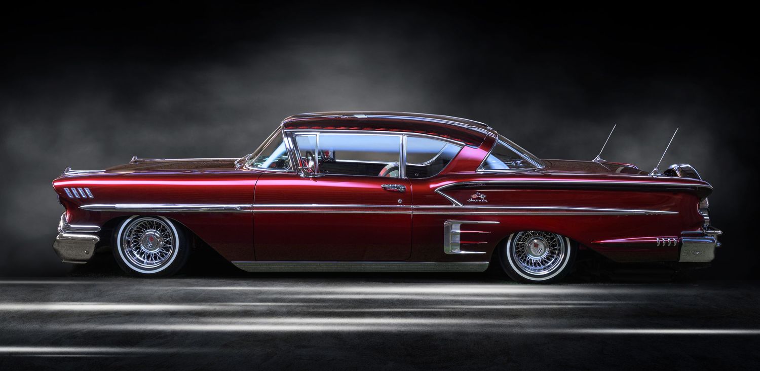 John Gayler Light Painting fine art wall portrait 1958 Chevrolet Impala Low Rider with luminous crimson color paint in a studio setting