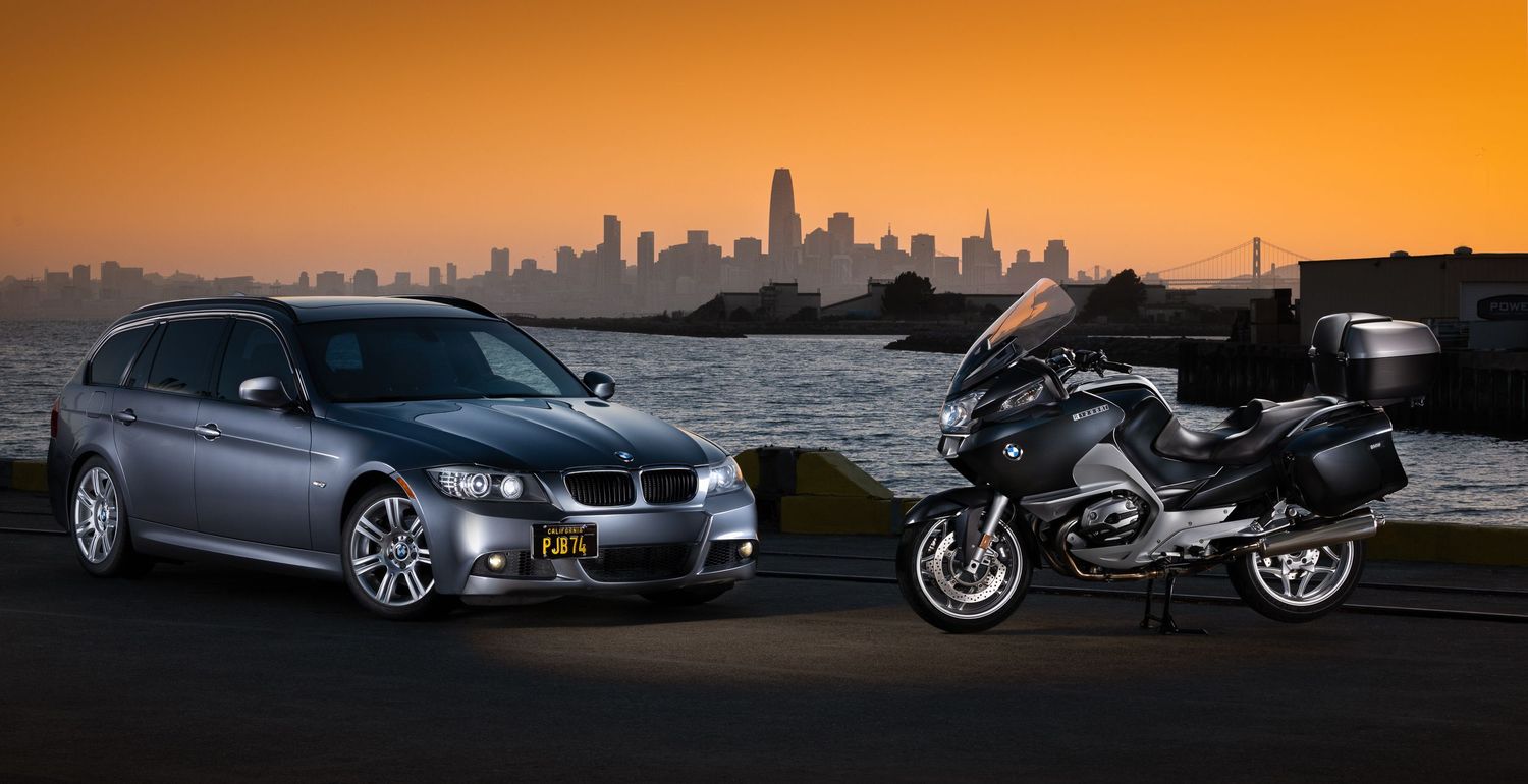 John Gayler Light Painting portrait of BMW 328i wagon and 1200RT BMW touring bike positioned against a vibrant San Francisco skyline sunset