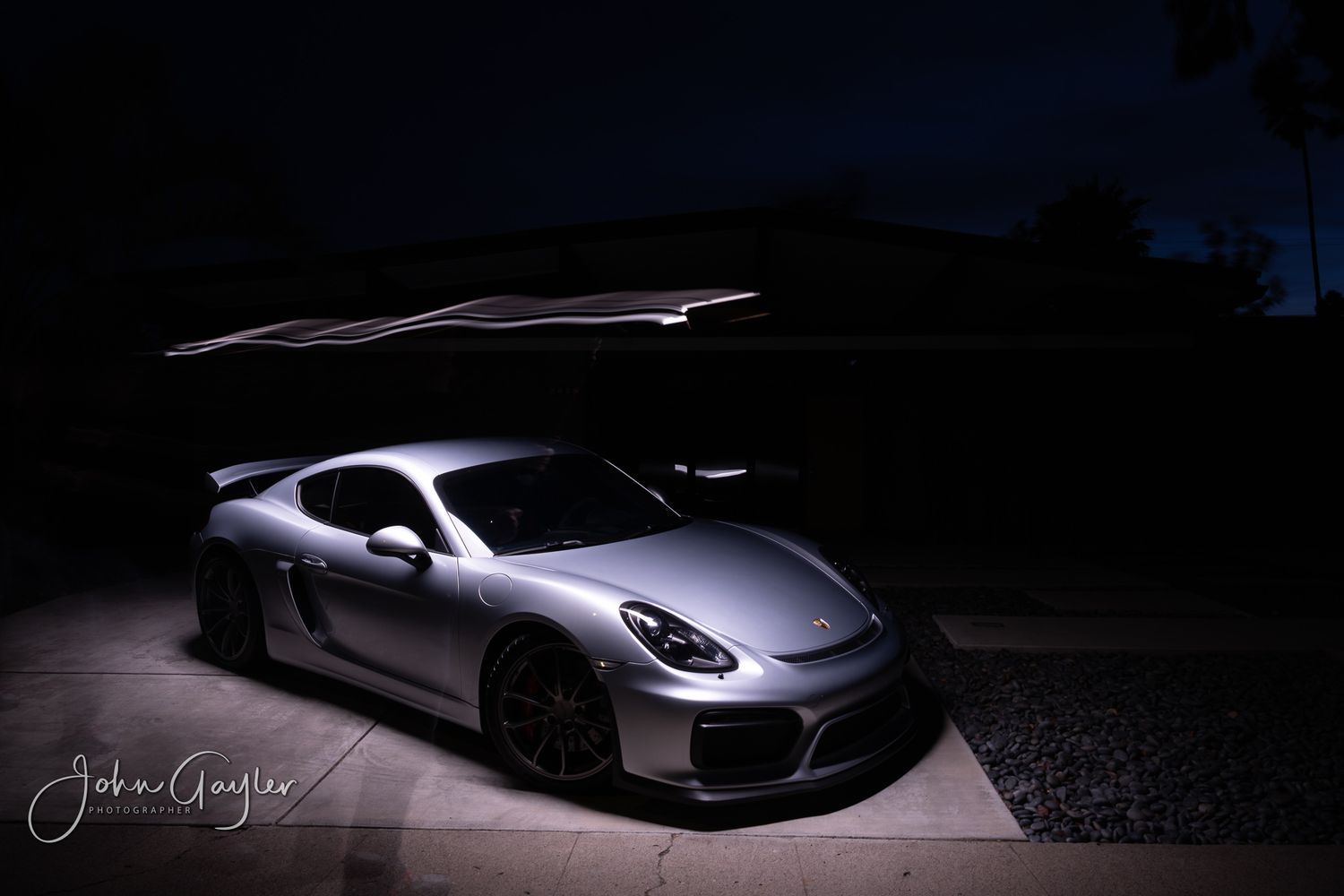 A single frame from a light painting series of a Porsche Carrera GT4 accentuates the lines and curves of the bodywork
