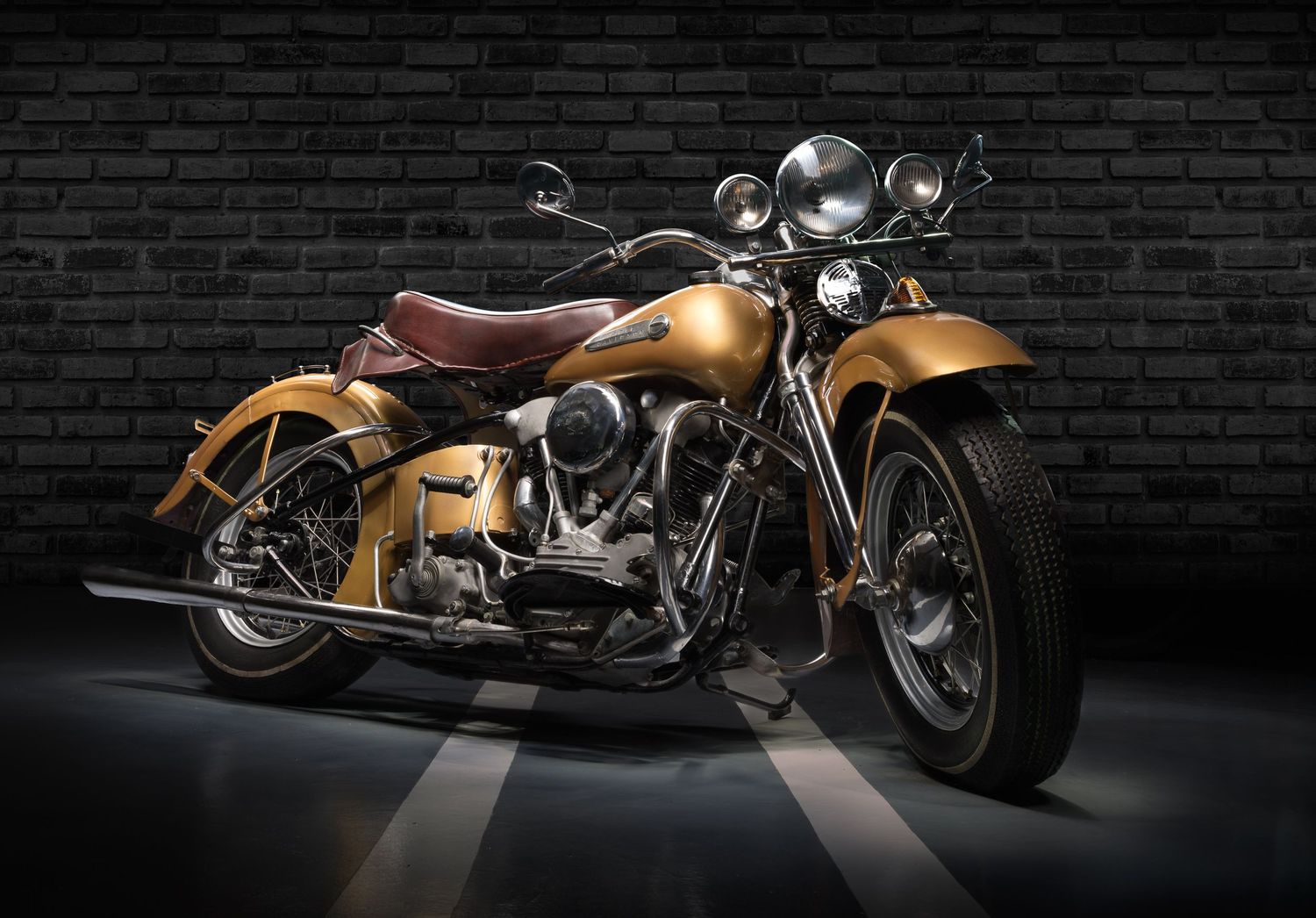 A  classic 1942 Harley Davidson Knucklehead motorcycle with gold paint in a fine art light painting bike portrait by john Gayler Photography