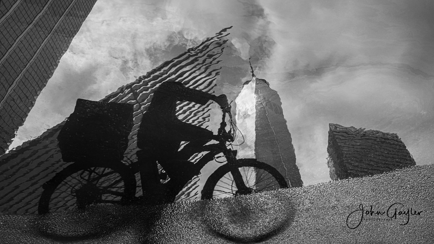 A delivery worker is silhouetted in a reflection as he rides below the Oculus Transportation Hub and World Trade Center standing tall in NYC