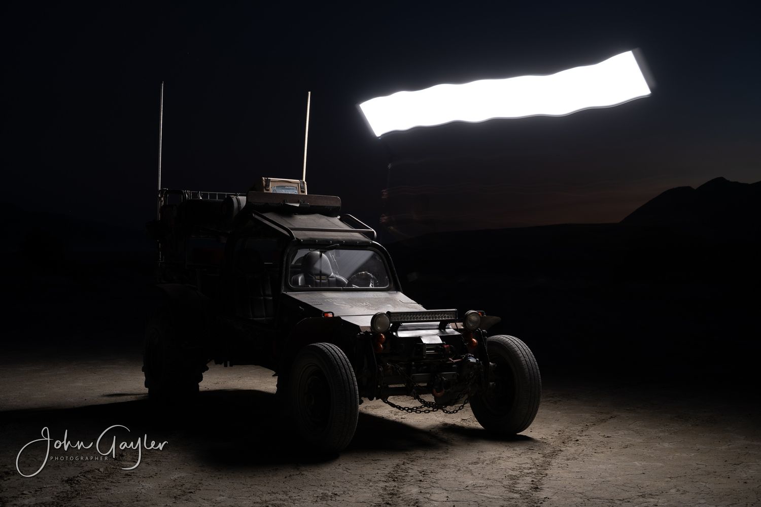 A single frame from a John Gayler light painting series of a custom off-road roadster accentuates details of the bodywork and accessories