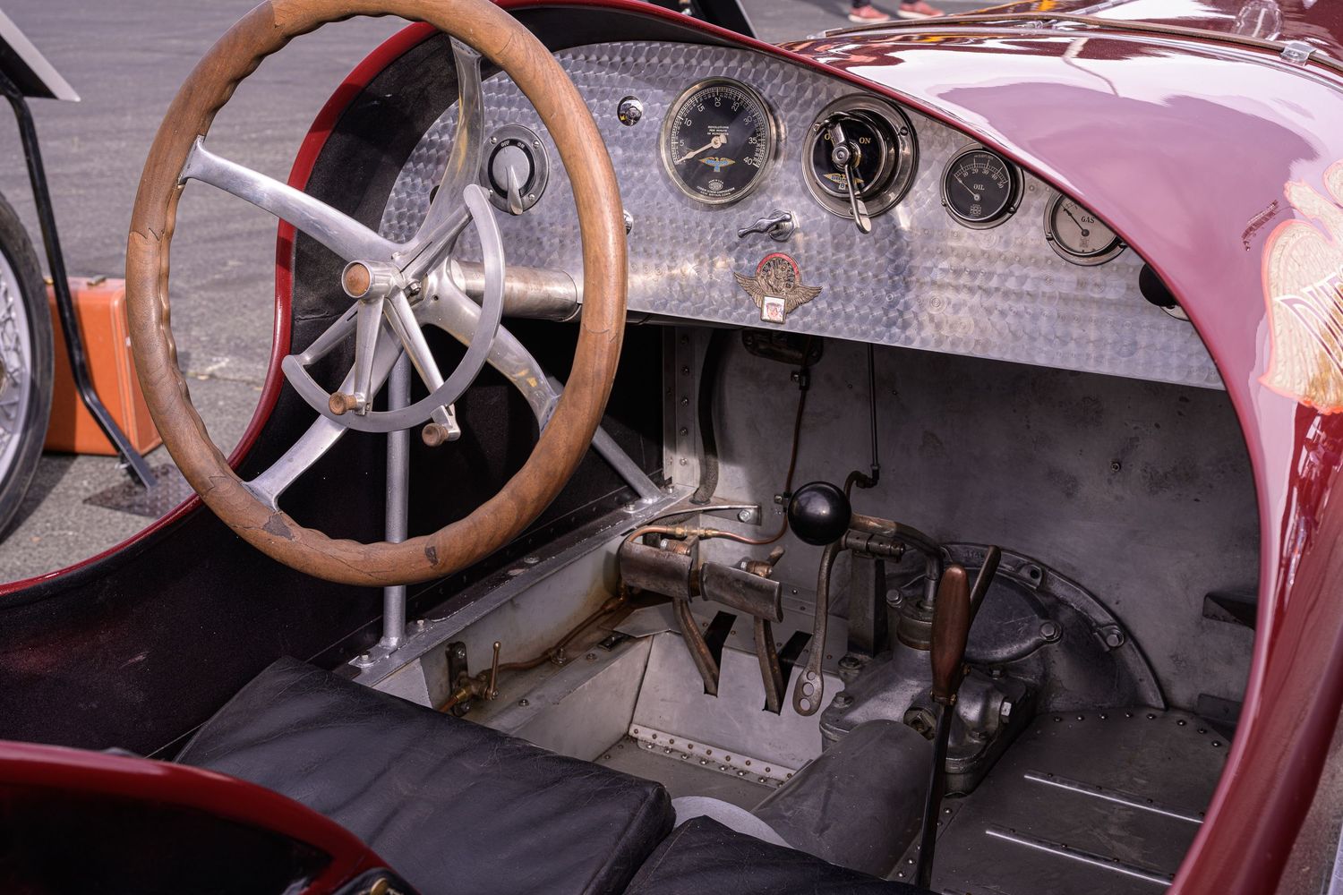 The Old Crow Speed Shop 1920 Duesenberg Straight 8 race car in the paddock at the Sonoma Speedway showing the cockpit controls and steering