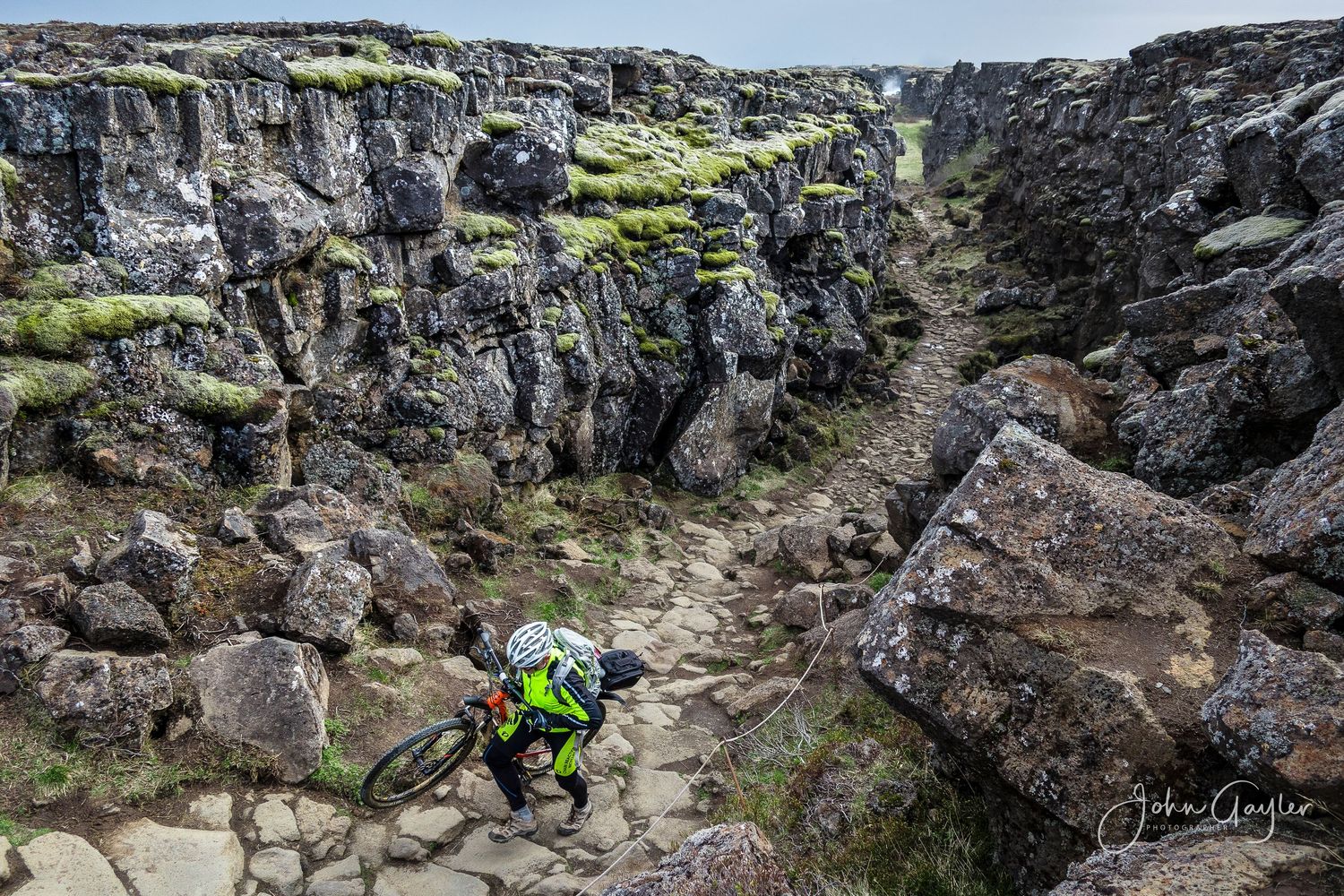 A mountain biker makes his way up the rugged path in between continents at the continental divide in Thingvellir, Iceland