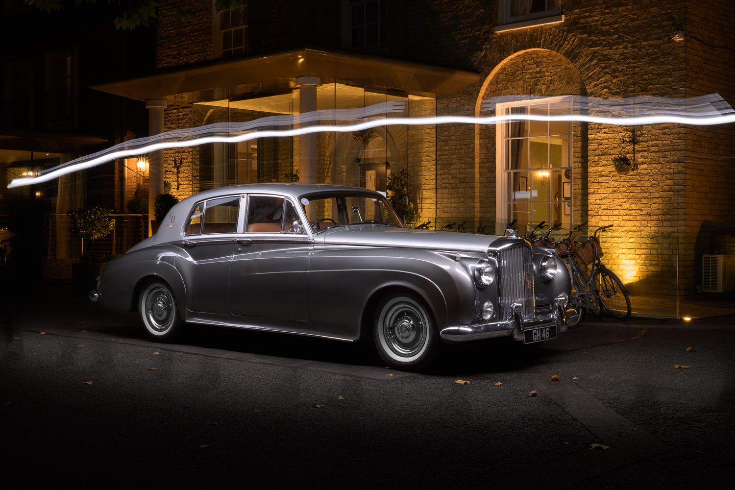 A single frame from a John Gayler light painting of a classic Bentley highlighting the curves of the limousine at the Gonville Hotel