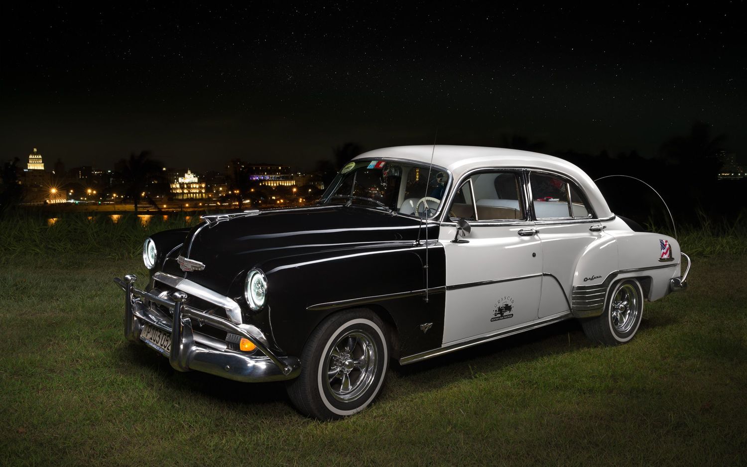 A John Gayler fine art wall portrait of a 1952 Chevrolet Styleline Deluxe Police Car now a classic taxi overlooking the city of Havana Cuba