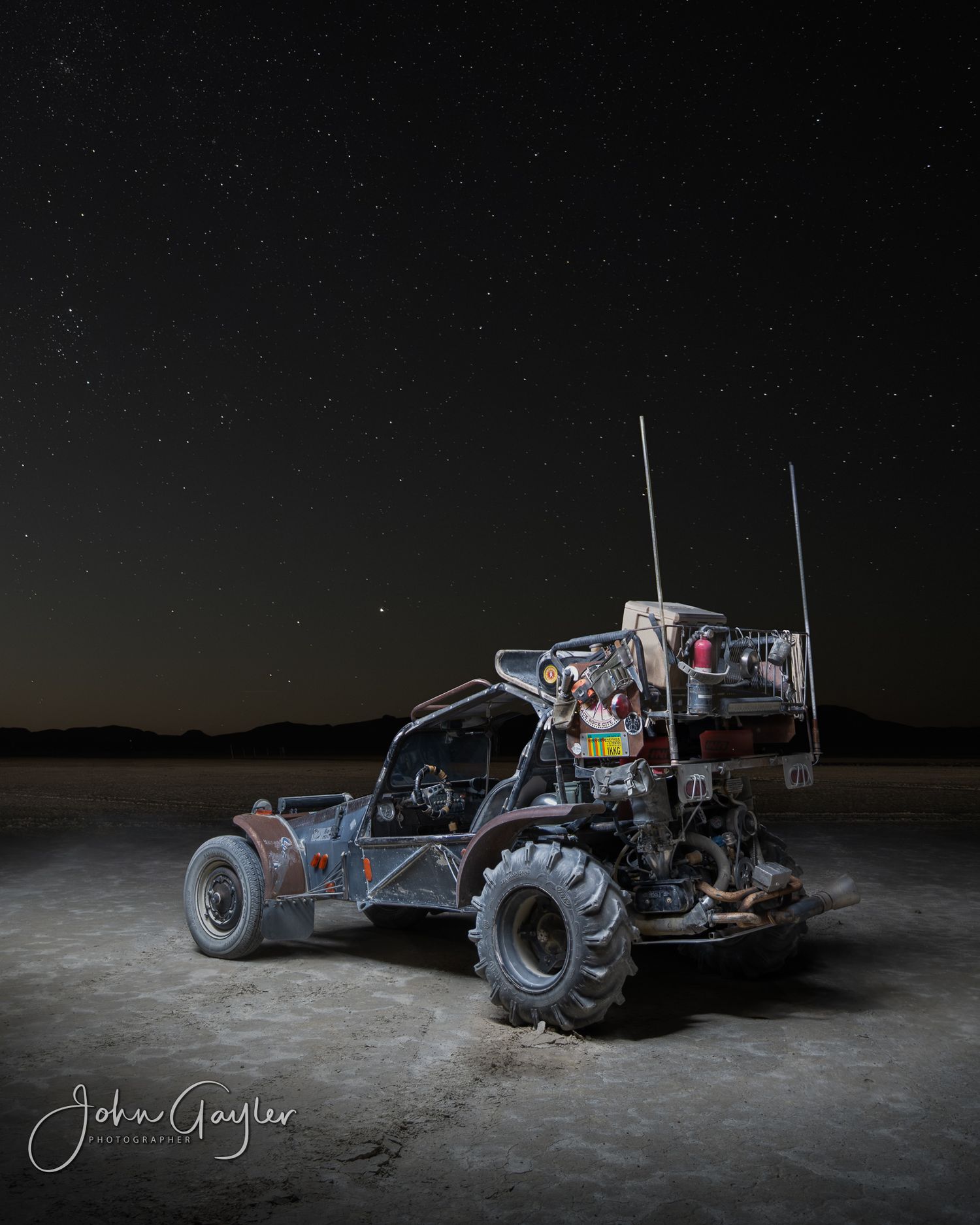 Mad Max on the Playa at Black Rock Desert rear view with a starry sky. A light painting for a fine art wall portrait by John Gayler