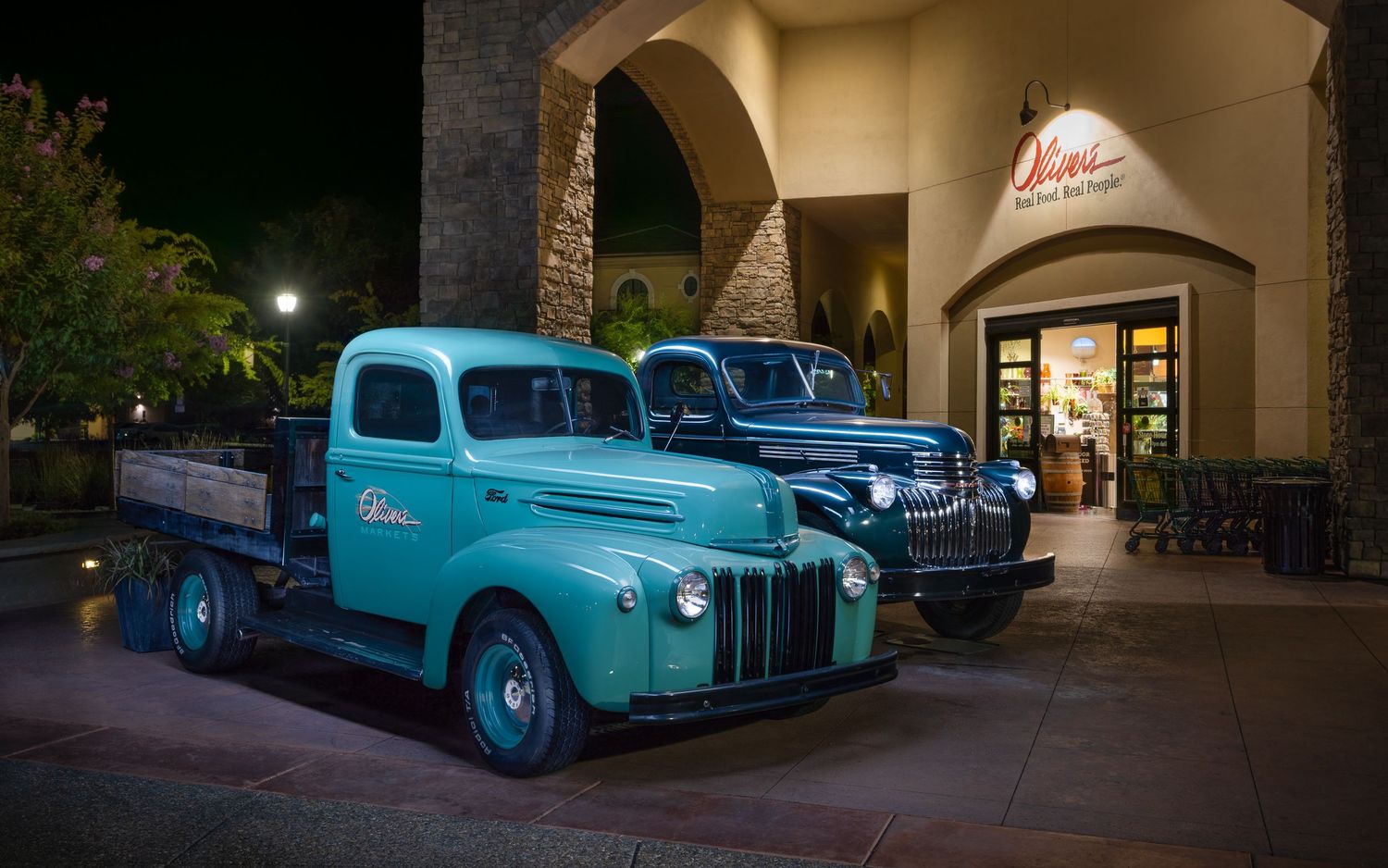 A John Gayler light painted portrait of Oliver's Market in Windsor, Northern CA with two vintage flat bed Ford delivery trucks outside