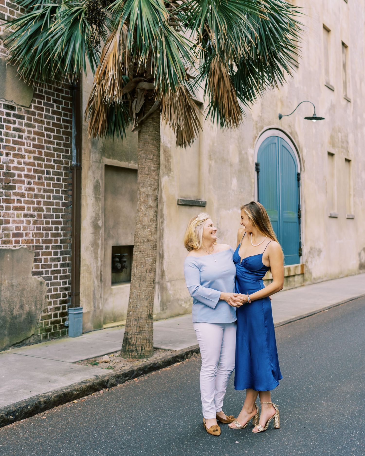Historic Charleston street scene with palm trees and traditional architecture.