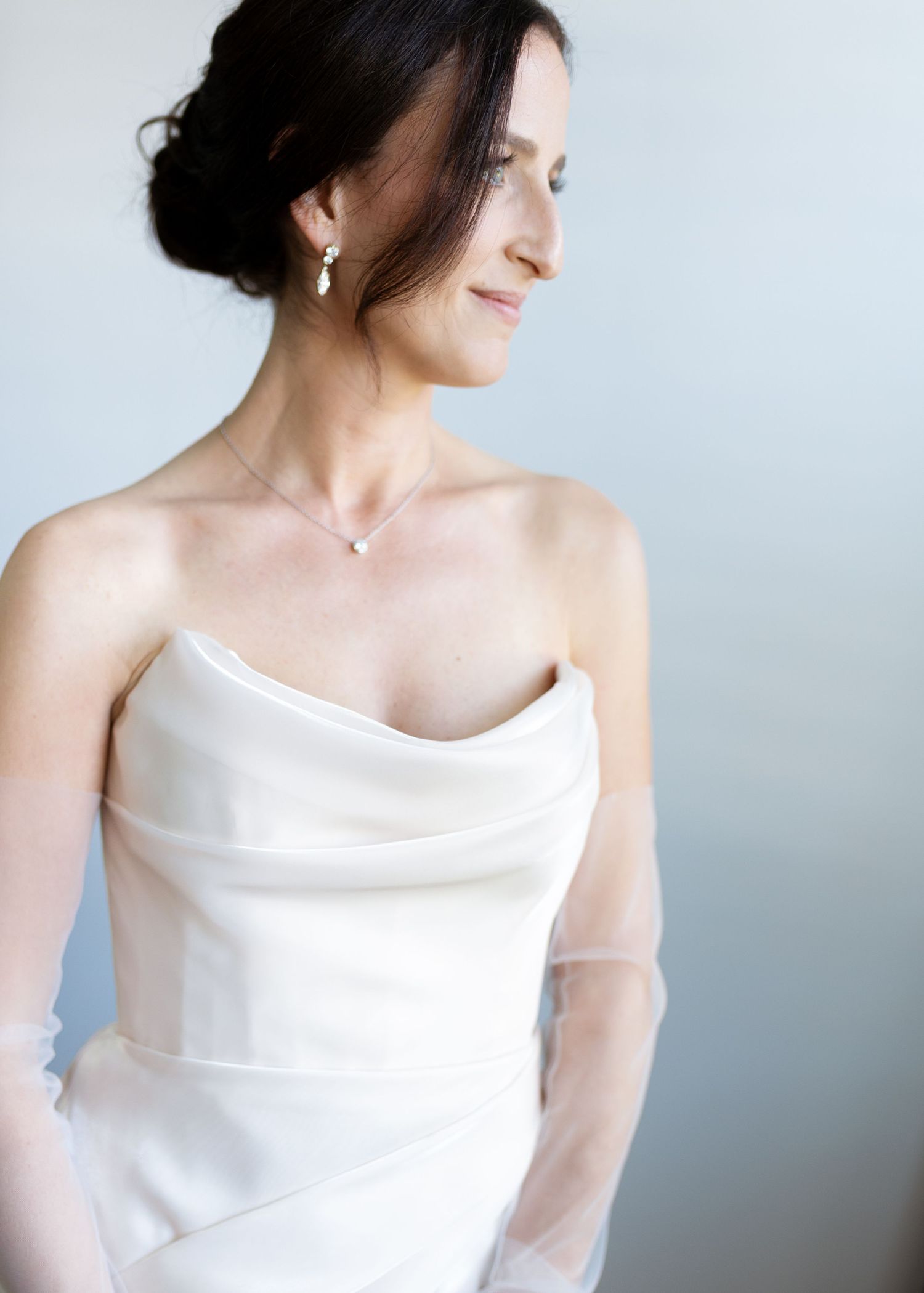 Elegant white wedding dress with cowl neckline shown in multiple angles against light background.