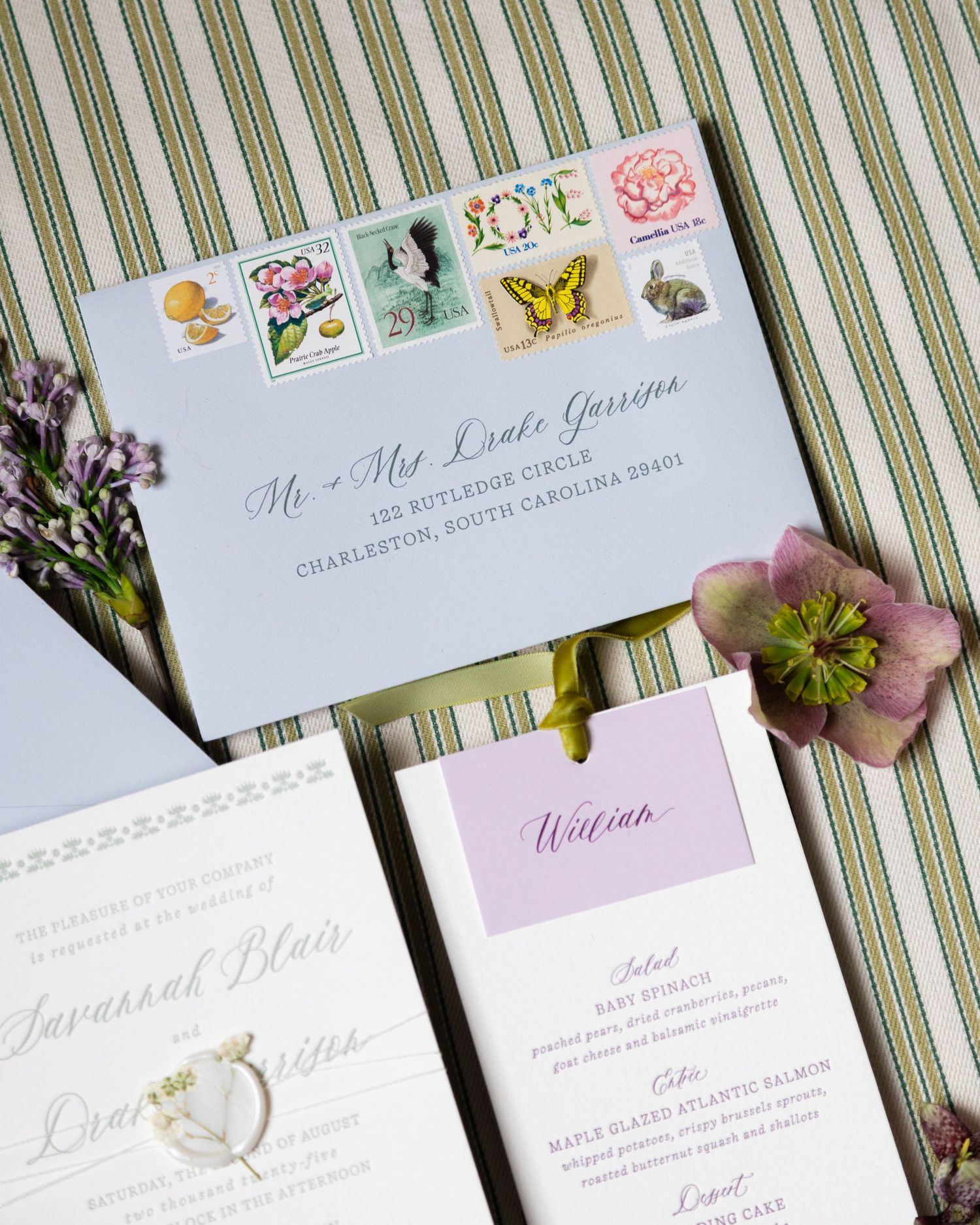 Wedding invitation suite featuring lavender accents and vintage postage stamps.