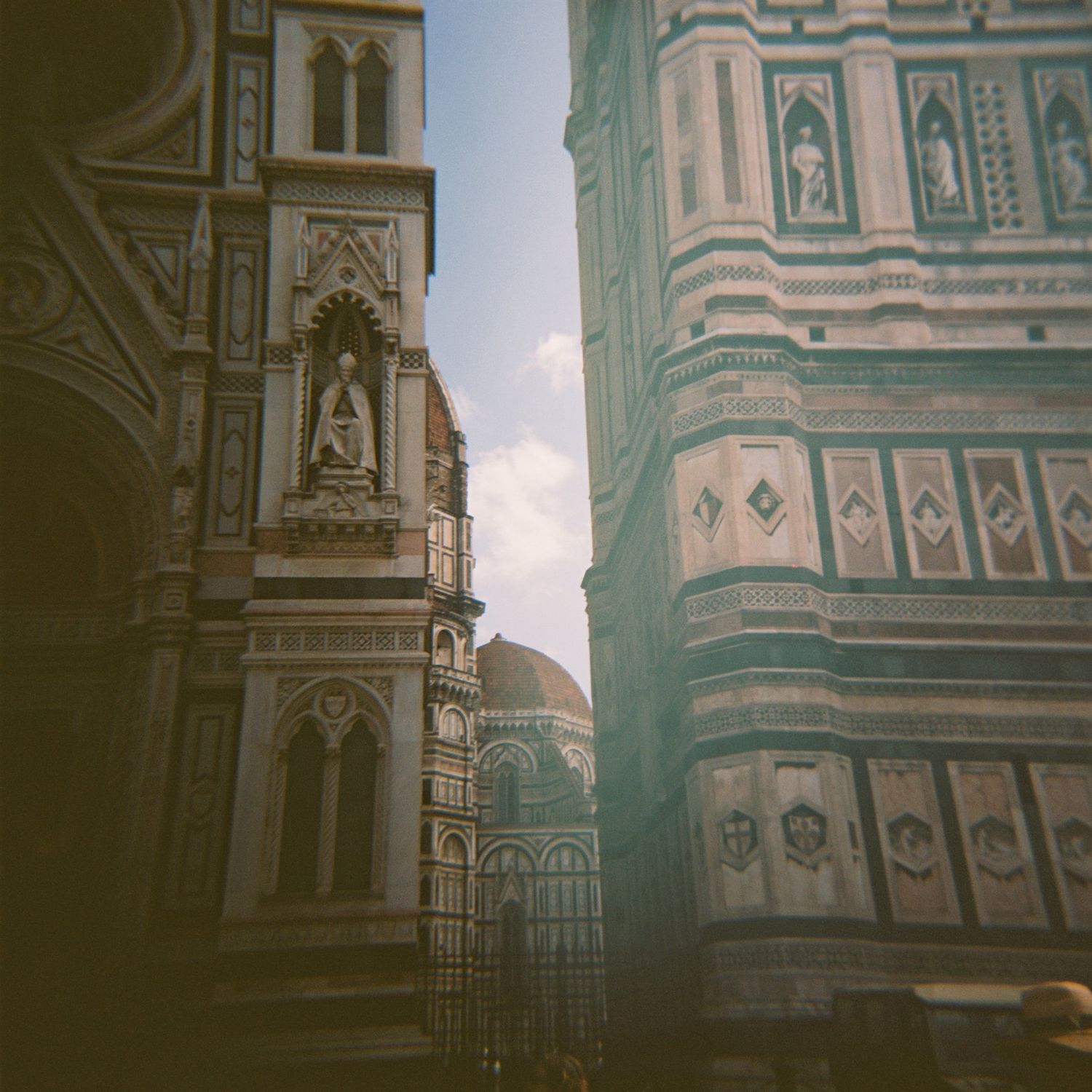 Historic cathedral architecture in Florence with ornate Gothic details and statues.