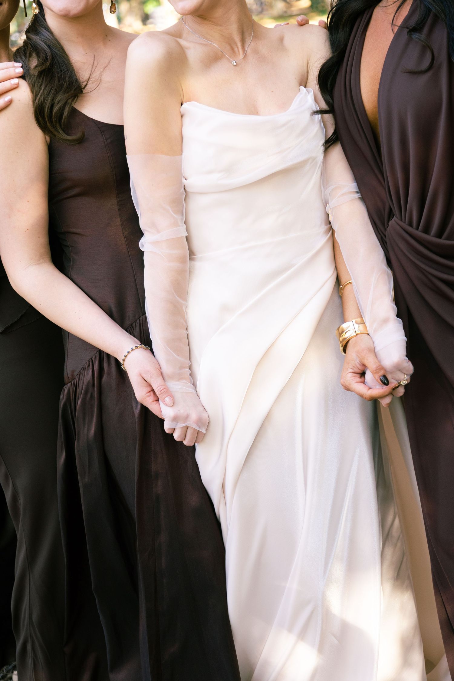 Wedding party wearing contrasting white and brown formal dresses.