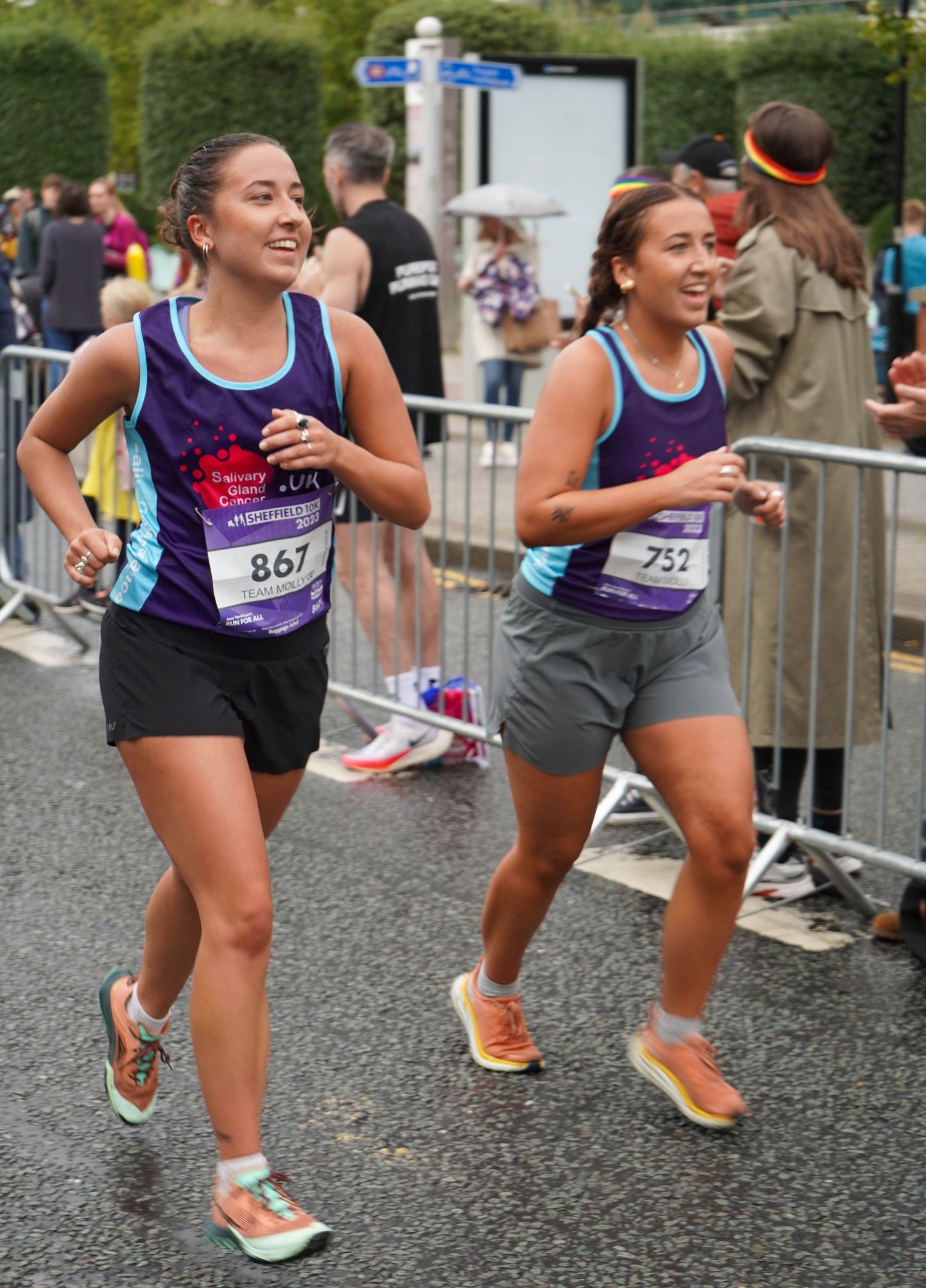 Athletes in athletic wear sprinting during a competitive road race event.